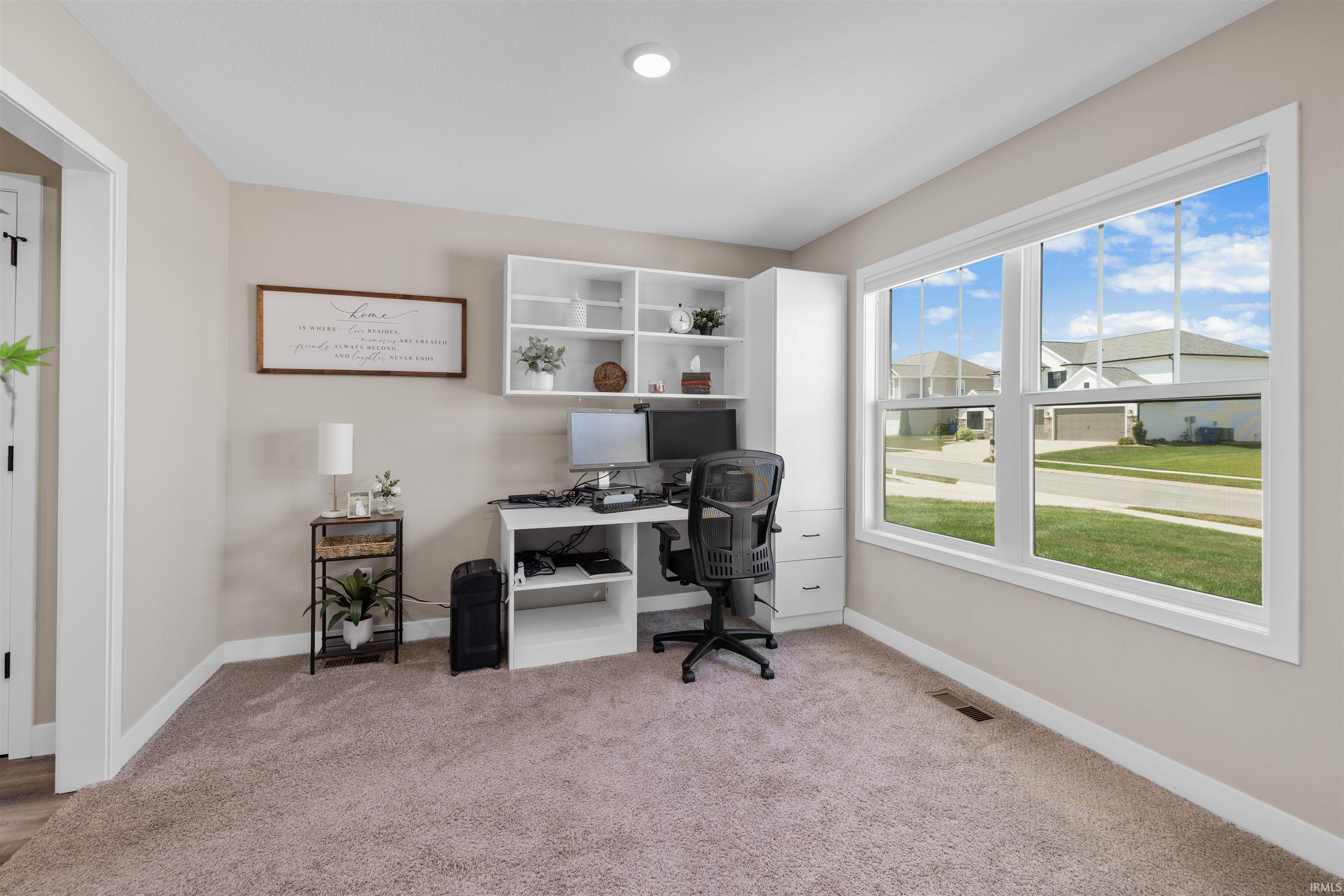 Carpeted room with neutral wall tones and white trim
