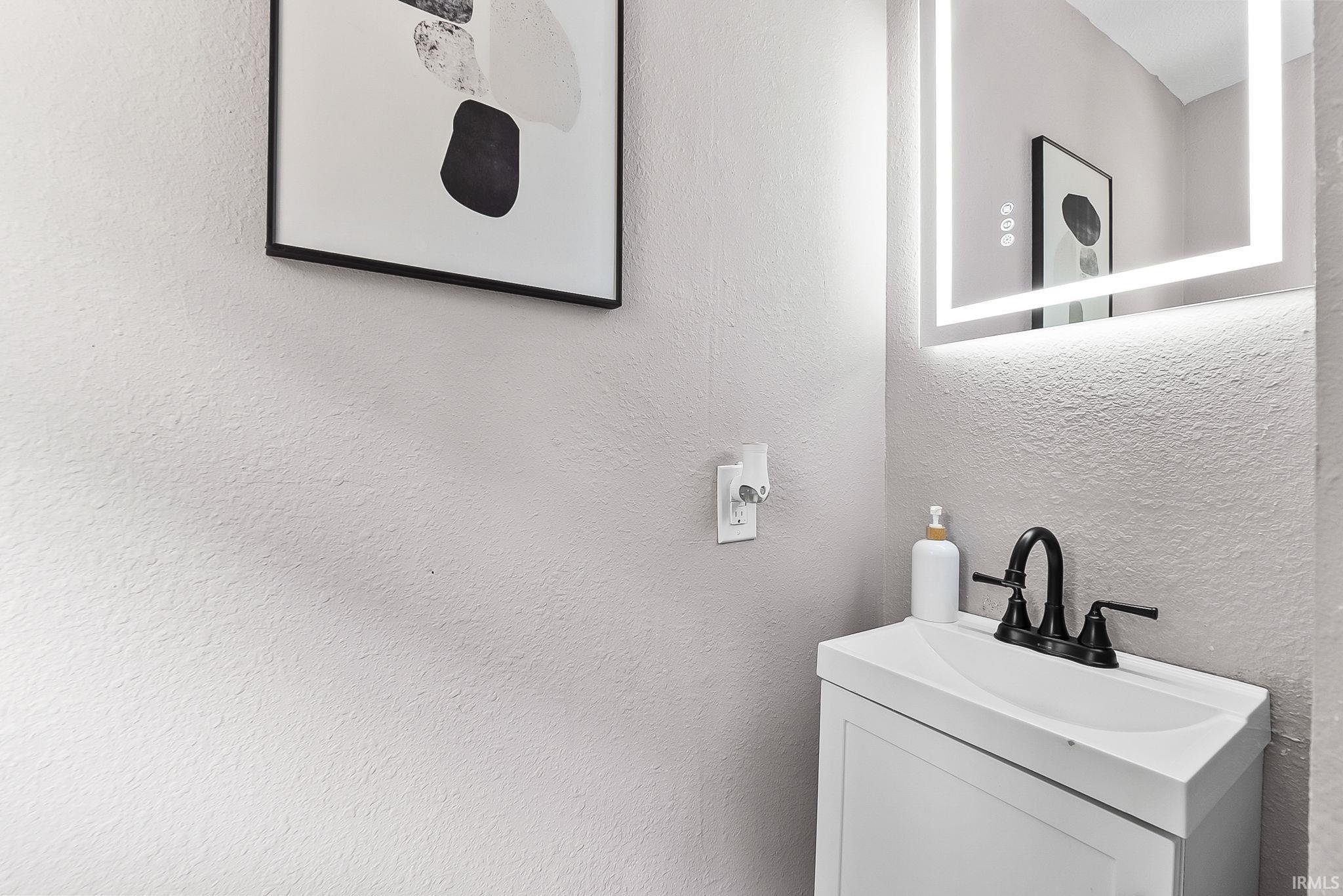 Modern vanity with an integrated white sink and matte black faucet