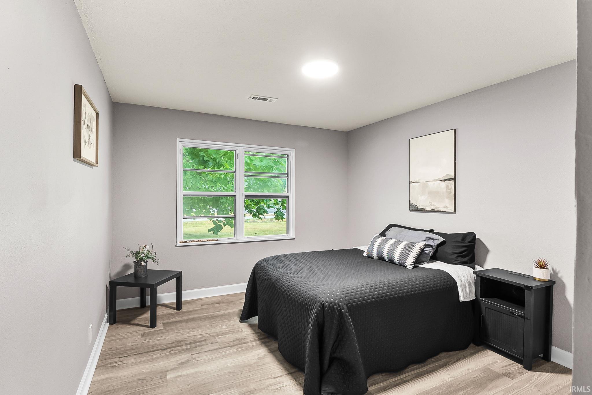 Neutral gray walls complement the wood-finish flooring