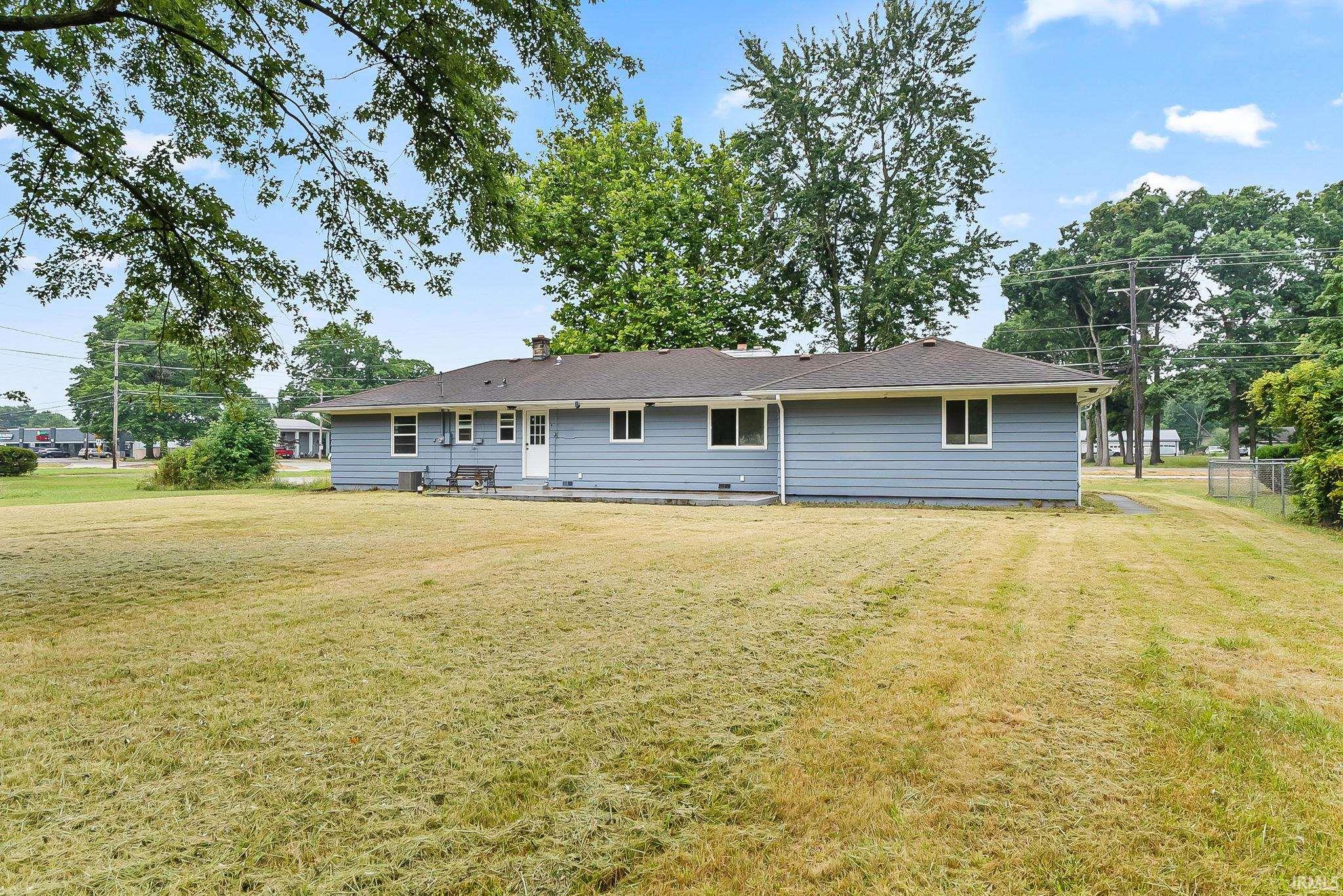 Expansive rear yard featuring a paved patio