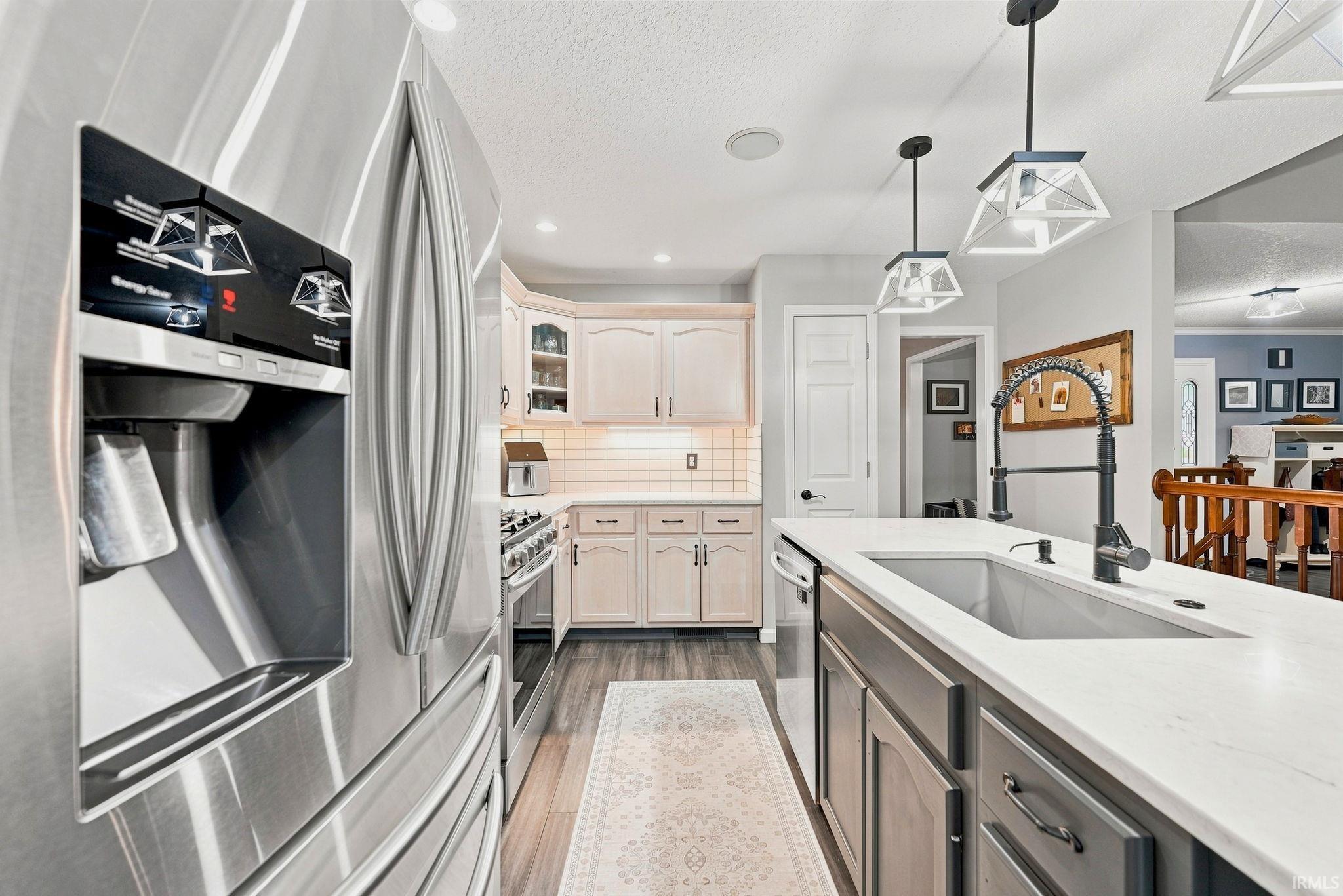 Modern kitchen featuring a stainless steel refrigerator with an external ice and water dispenser