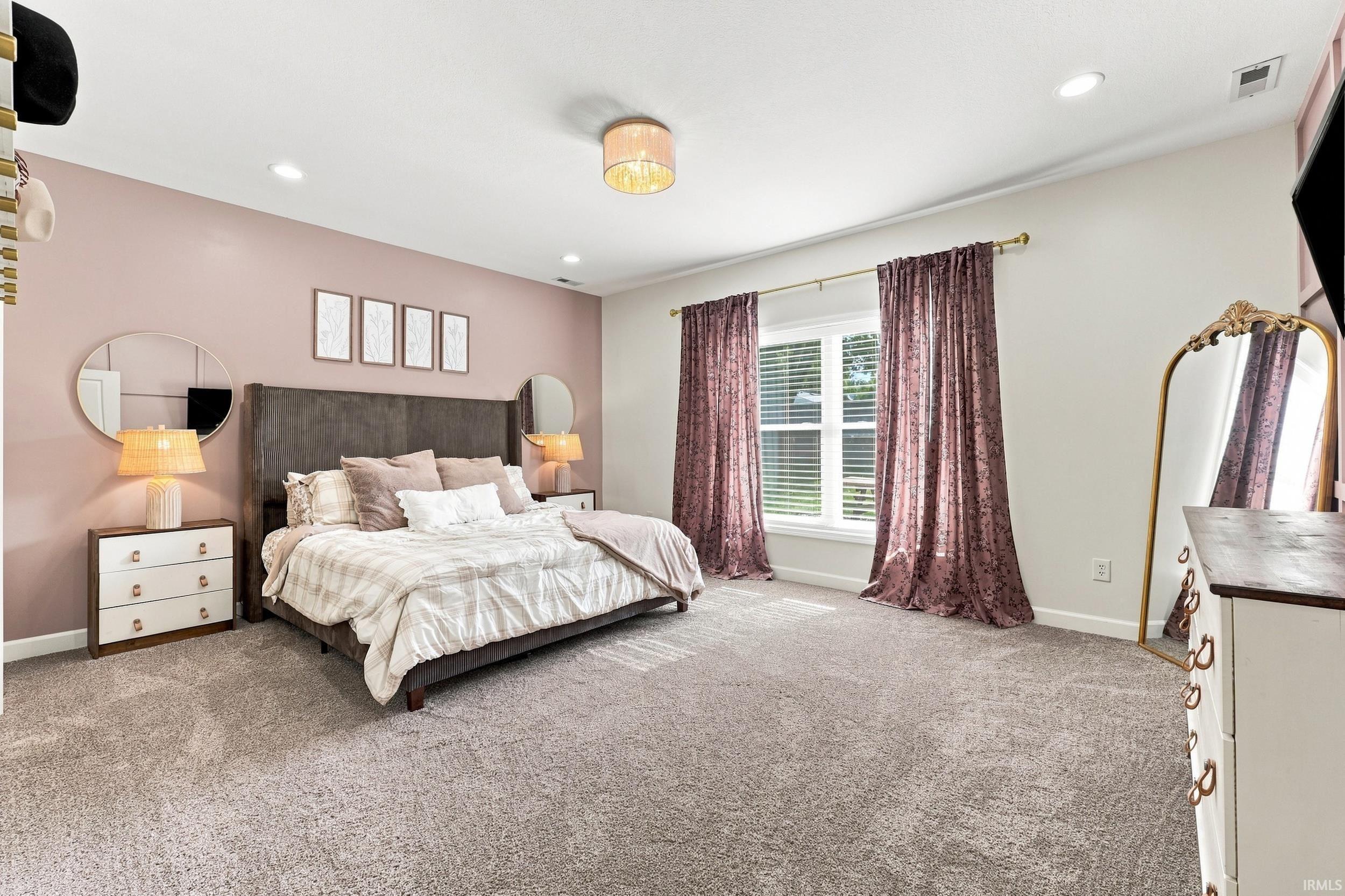 Spacious room featuring broadloom carpeting, recessed lighting, and a window with blinds