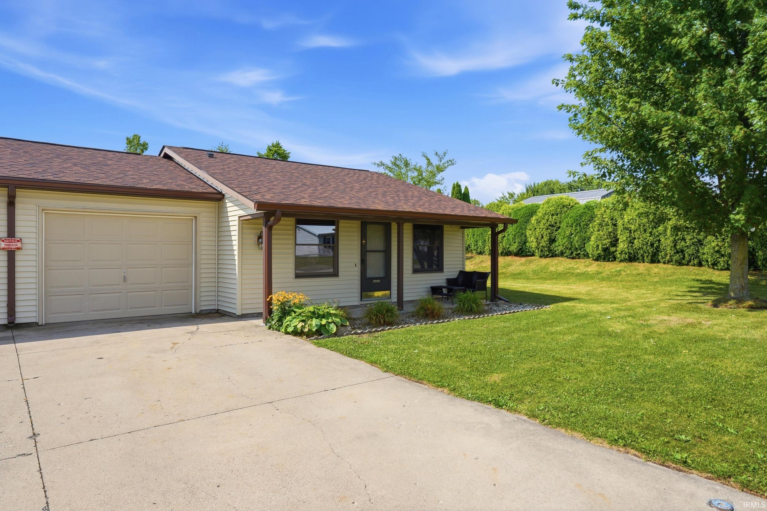 Single-story residence featuring light-colored siding and a covered front porch
