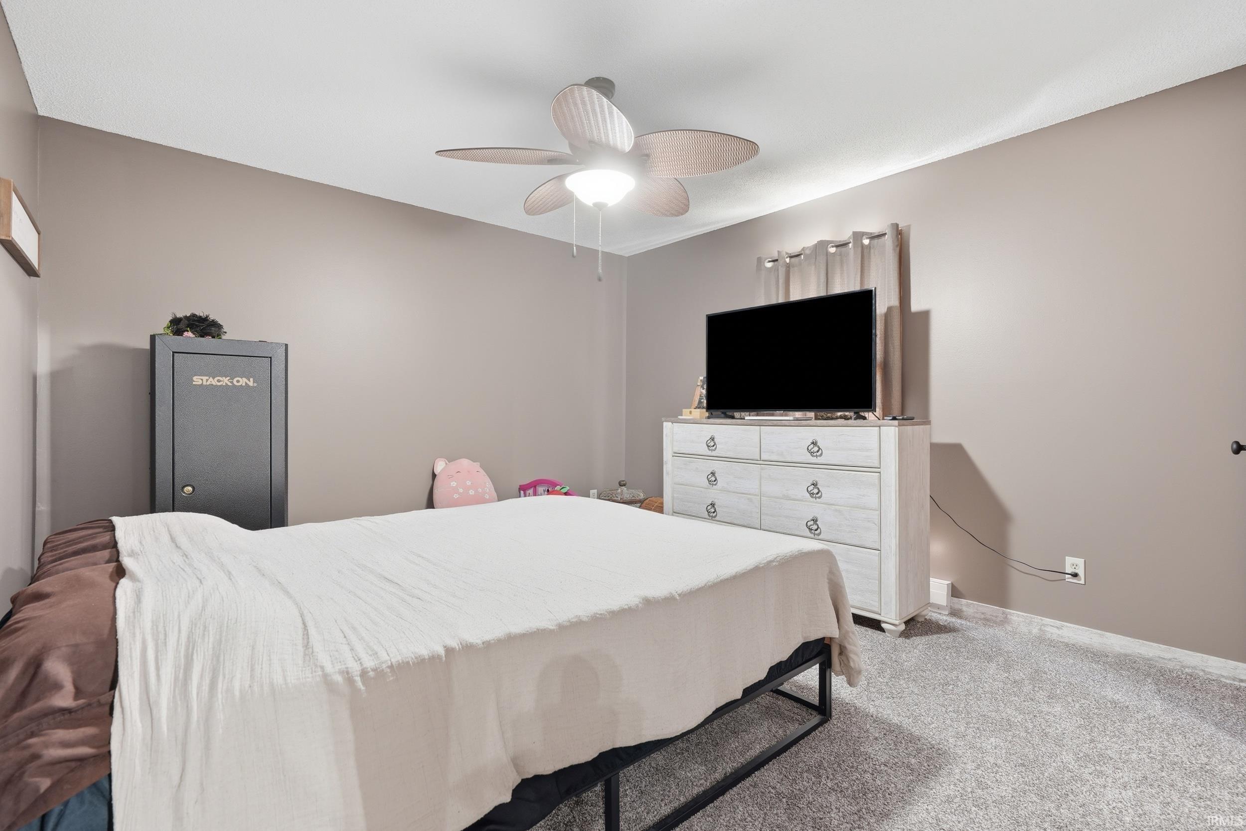 Wall-to-wall carpeting and neutral wall tones create a calm atmosphere