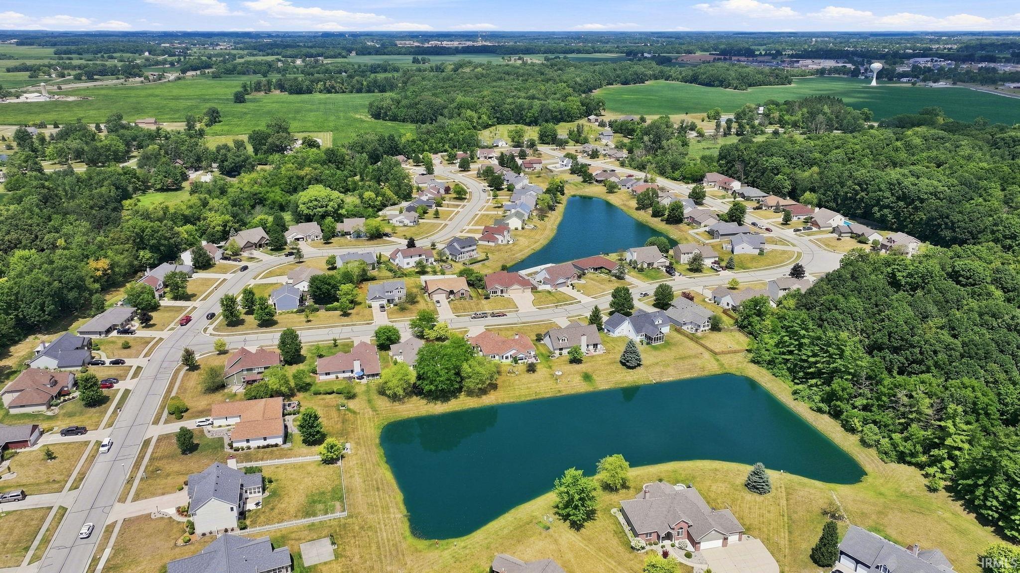 Aerial perspective showcasing a residential community with two distinct ponds