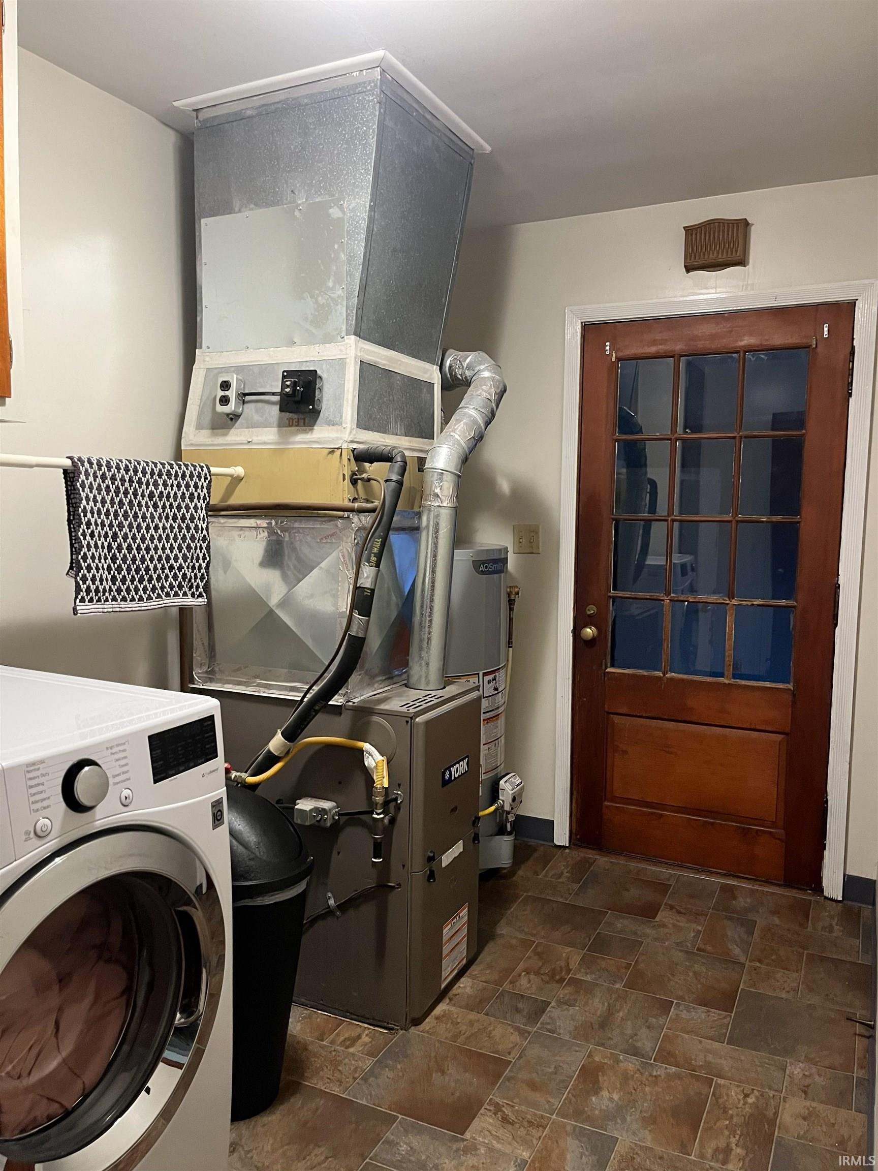 Utility area featuring a furnace and water heater