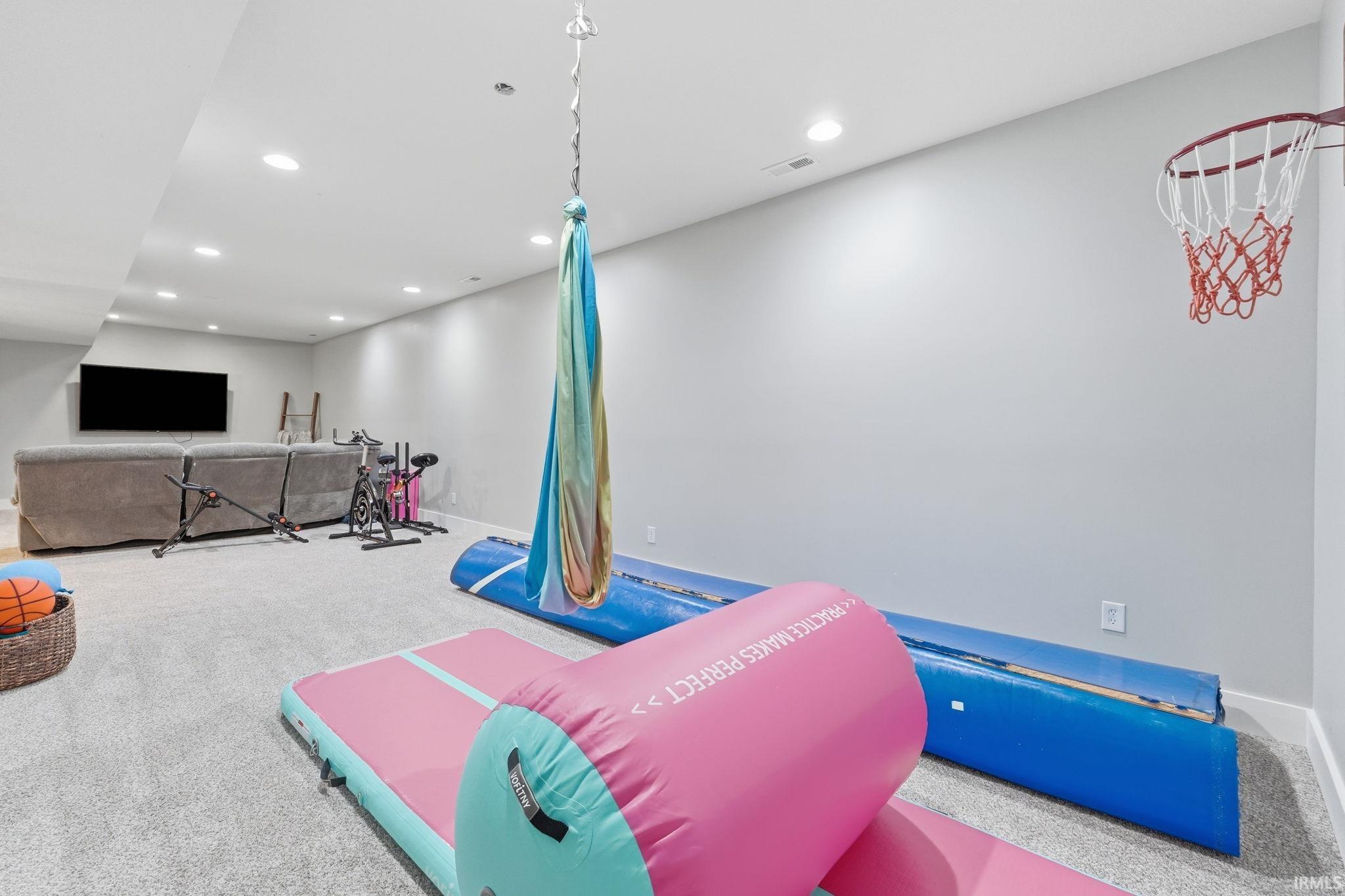 Spacious finished basement featuring recessed lighting, light gray carpeting, and a neutral wall color