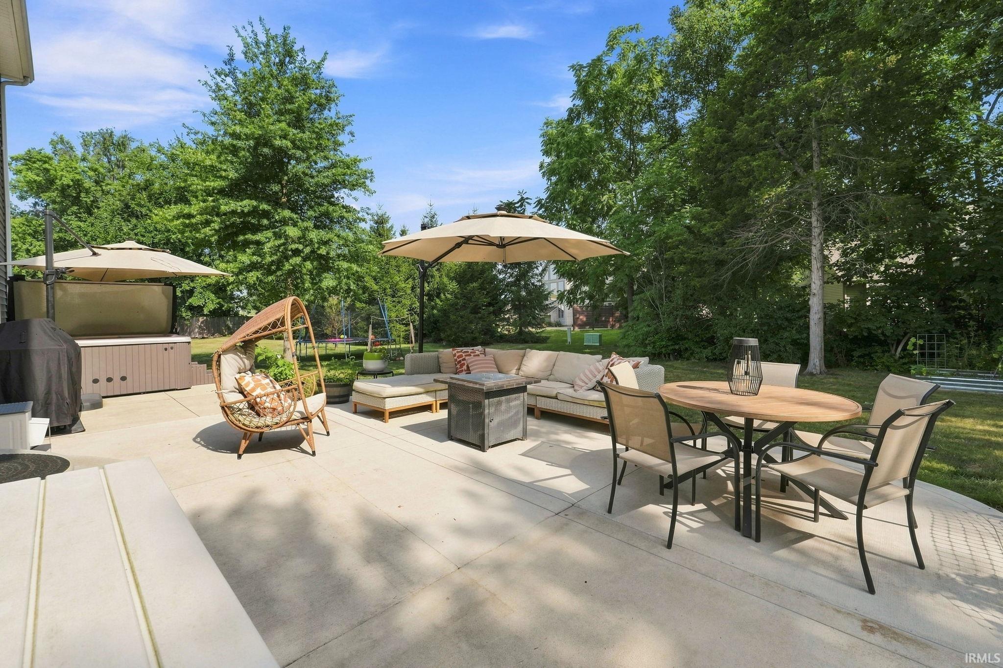Expansive concrete patio offering multiple zones for outdoor living