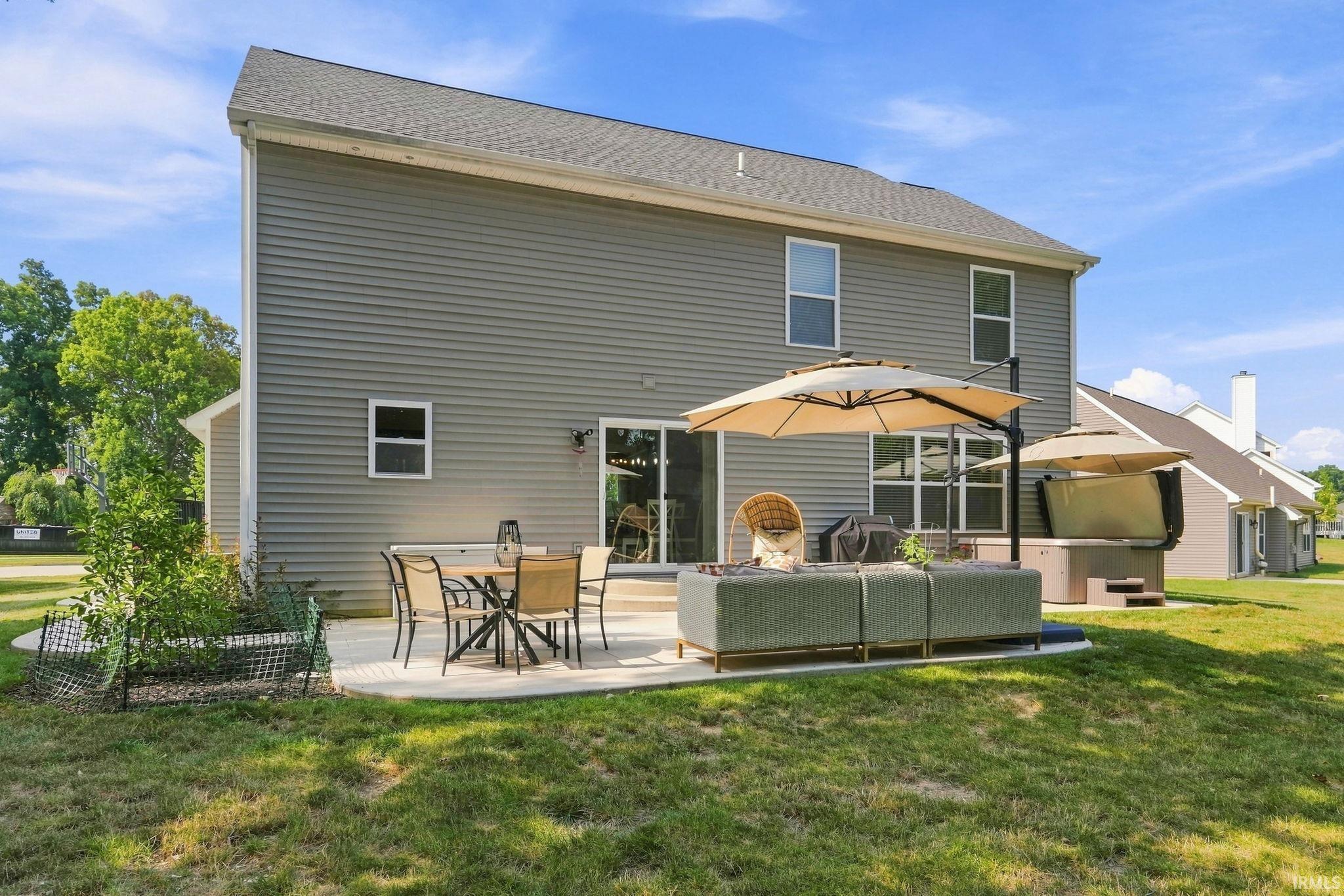 Rear exterior featuring gray horizontal siding and a gabled roofline