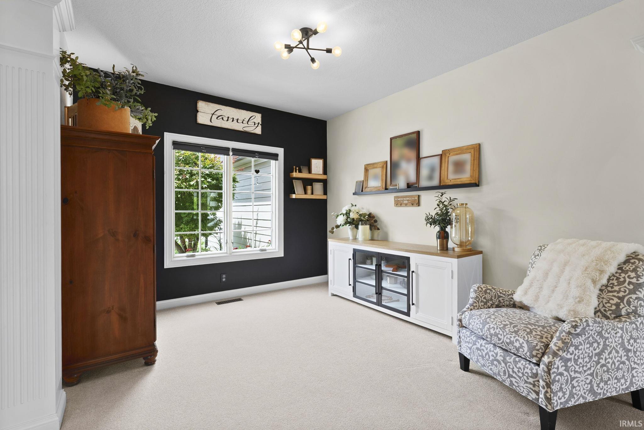 Light-toned carpeting complements the neutral wall color