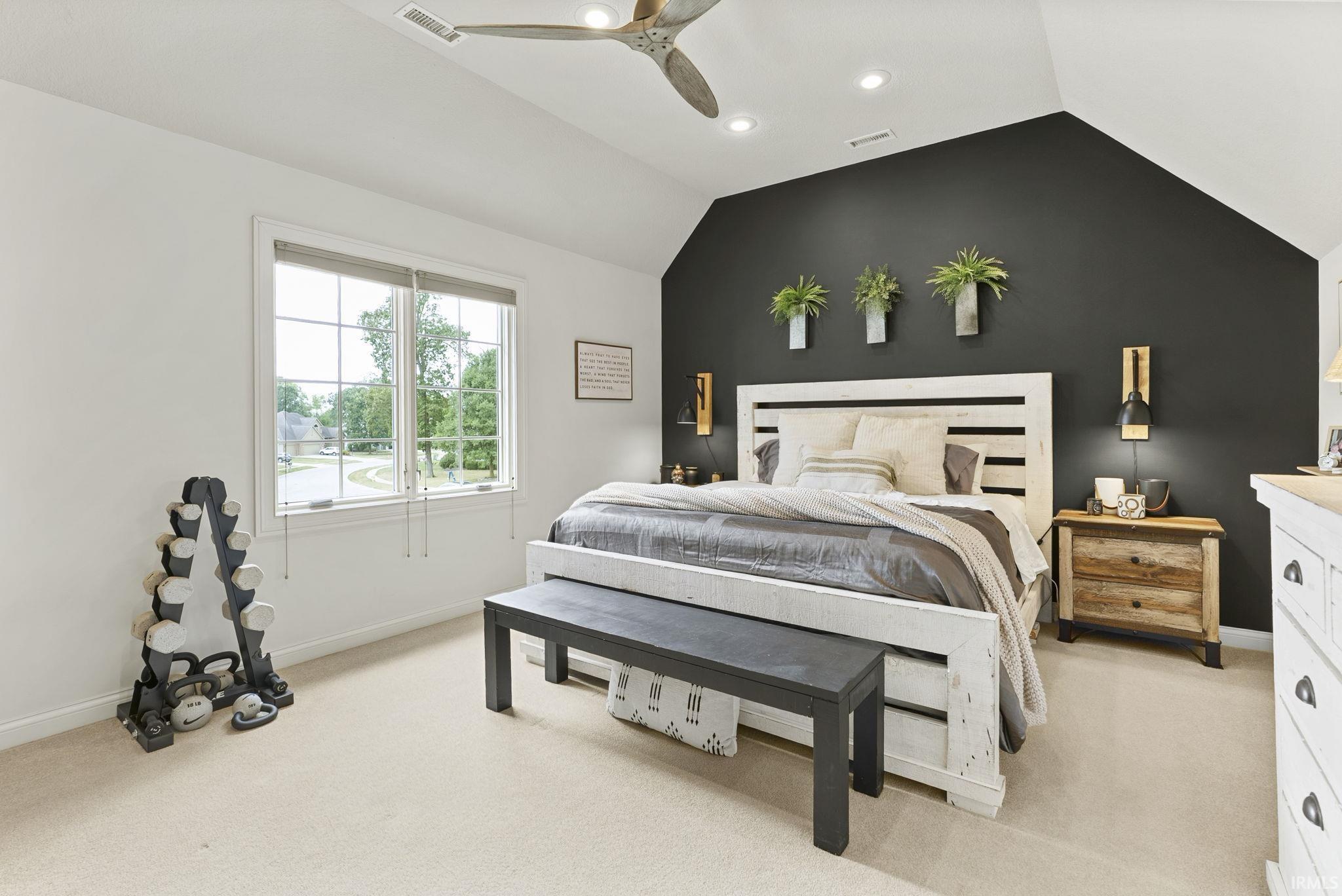Spacious room with plush carpeting and a vaulted ceiling