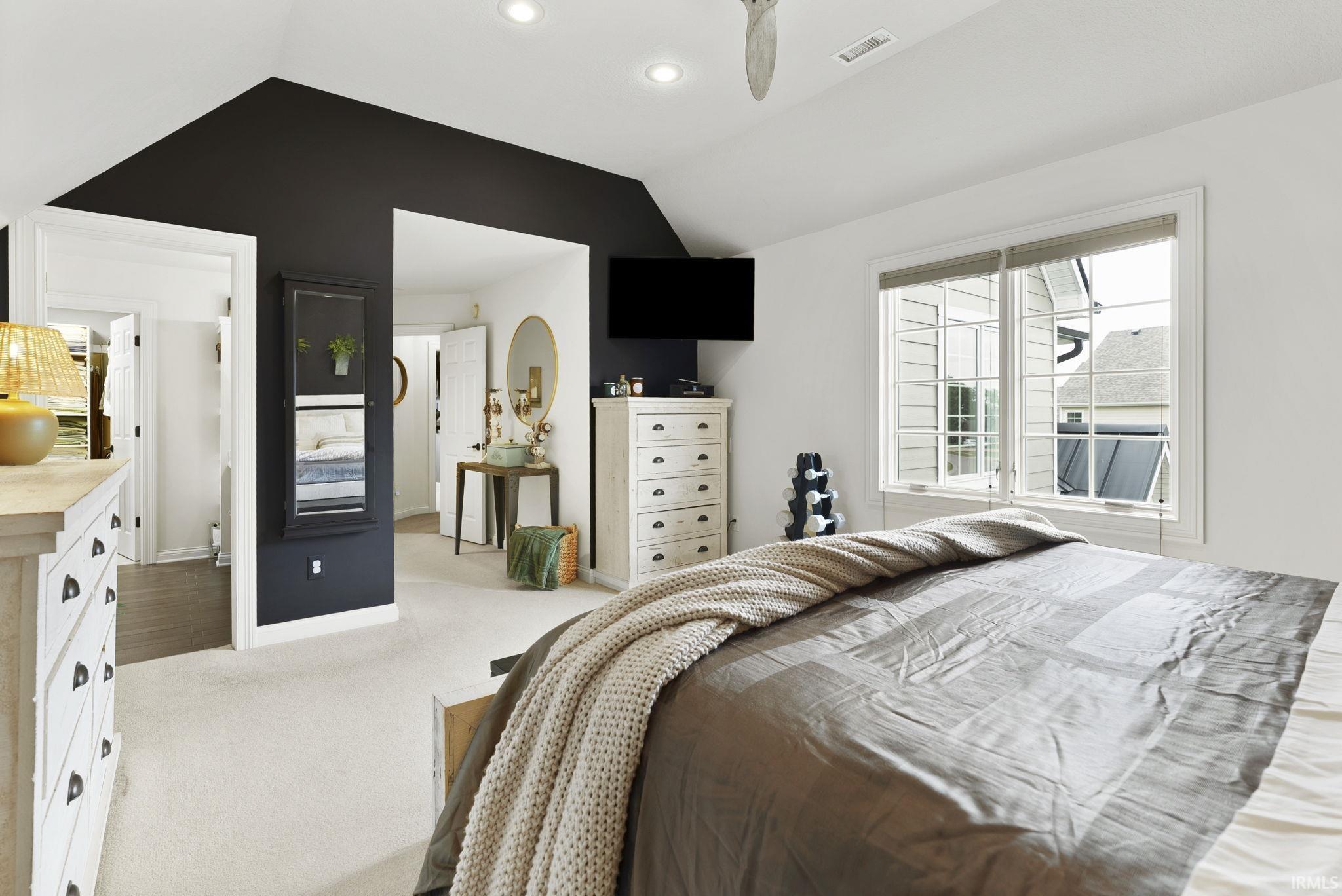 Vaulted ceiling bedroom featuring recessed lighting, a ceiling fan, and carpet flooring