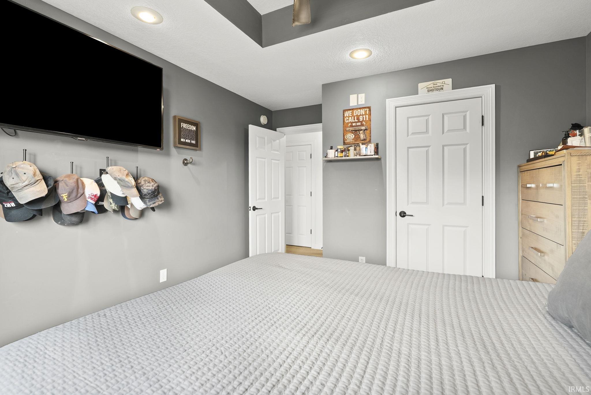Recessed ceiling lighting illuminates a tray ceiling with a ceiling fan