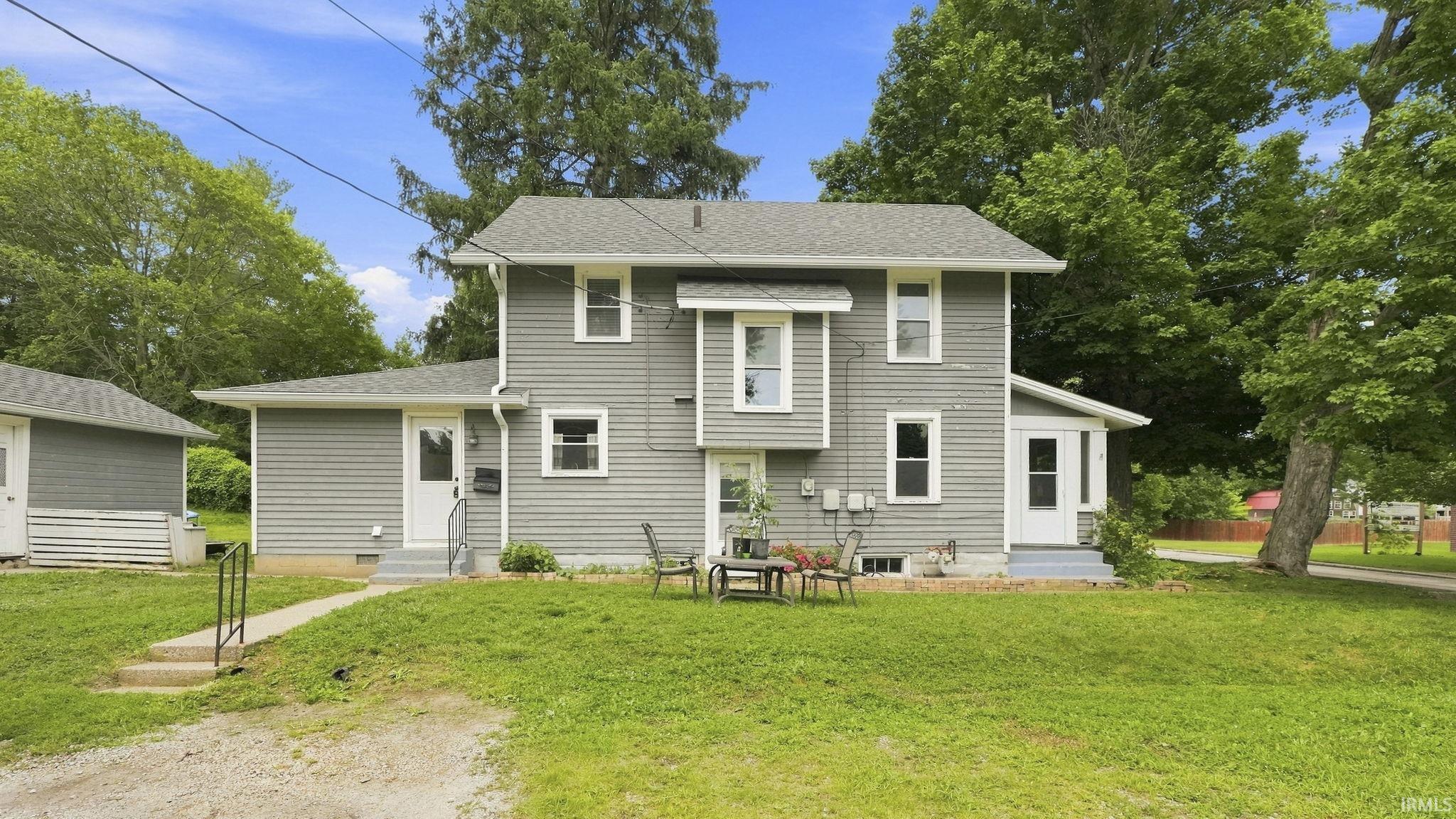 Two-story exterior with gray horizontal siding and white trim