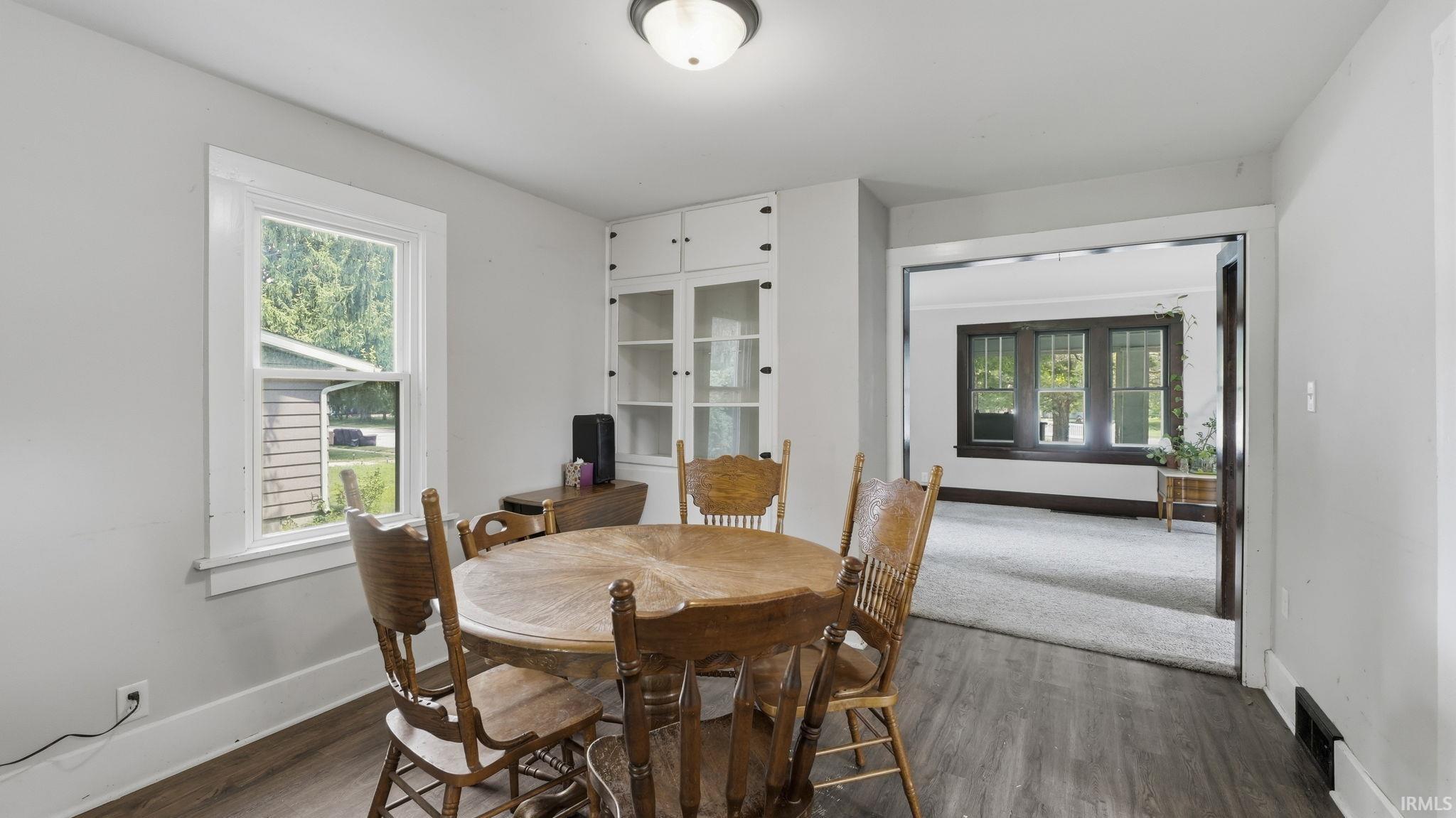 Dining area featuring wood-finish flooring and light gray walls