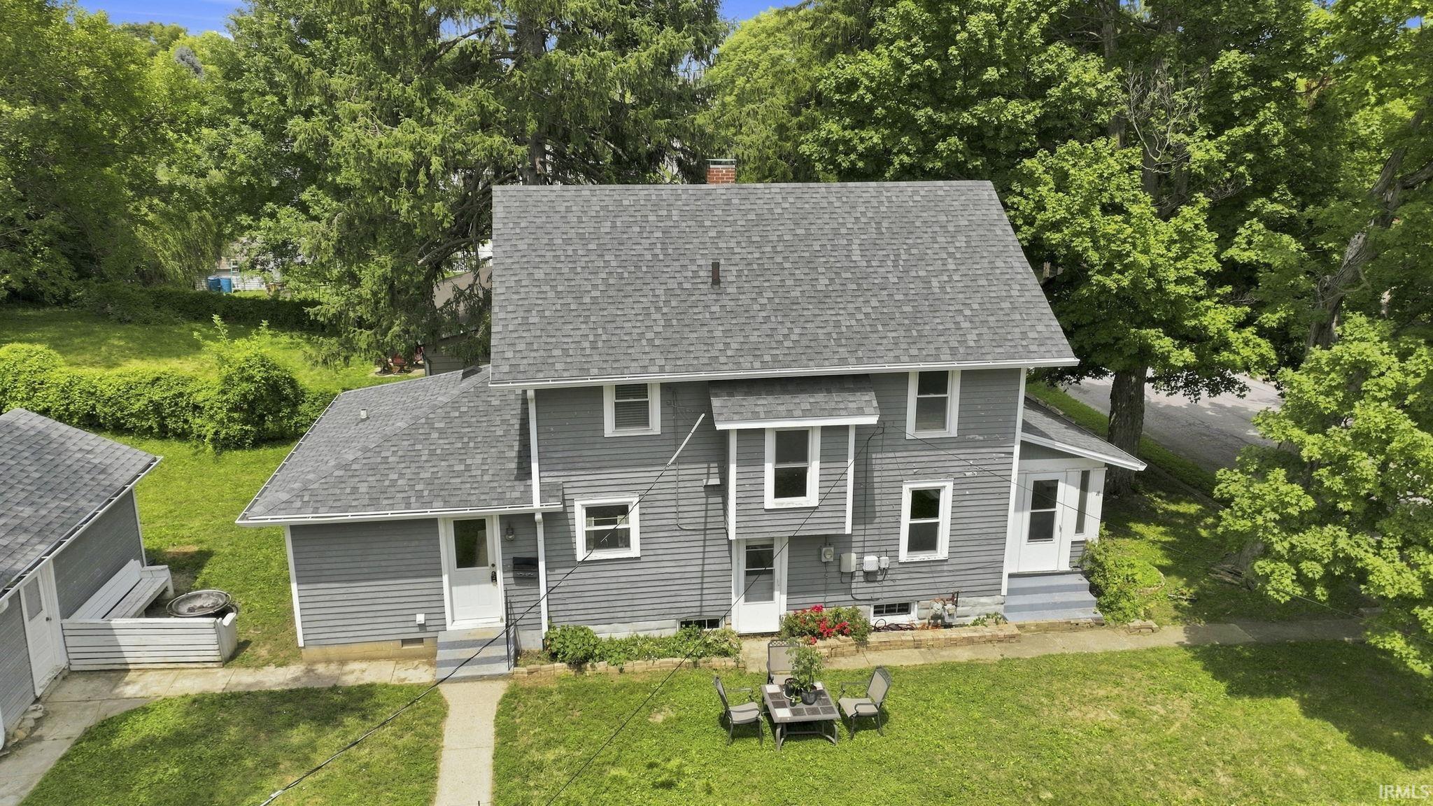 Two-story gray siding residence featuring a gray asphalt shingle roof