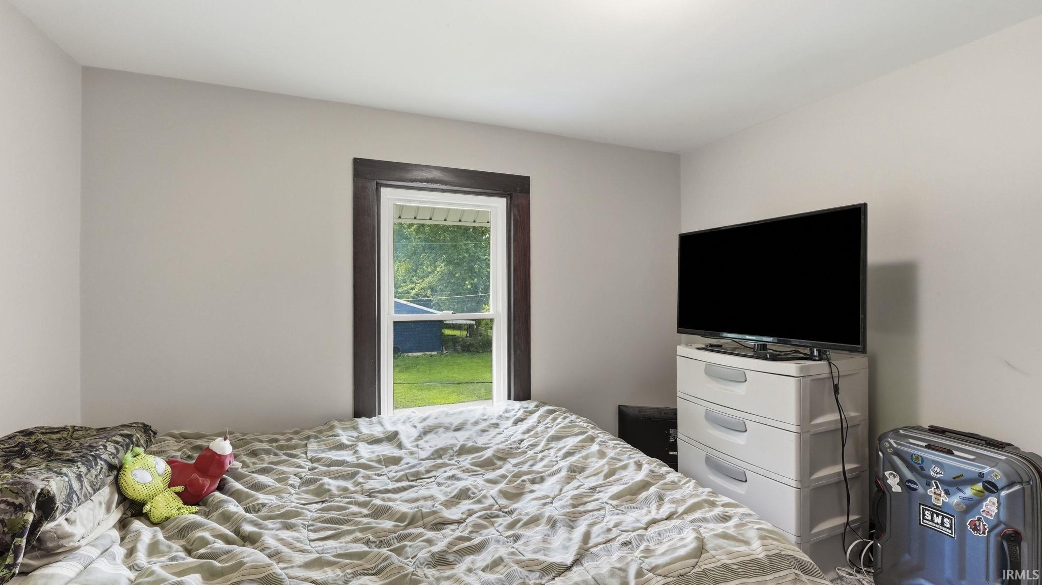 Neutral-toned interior walls featuring a single window with dark trim
