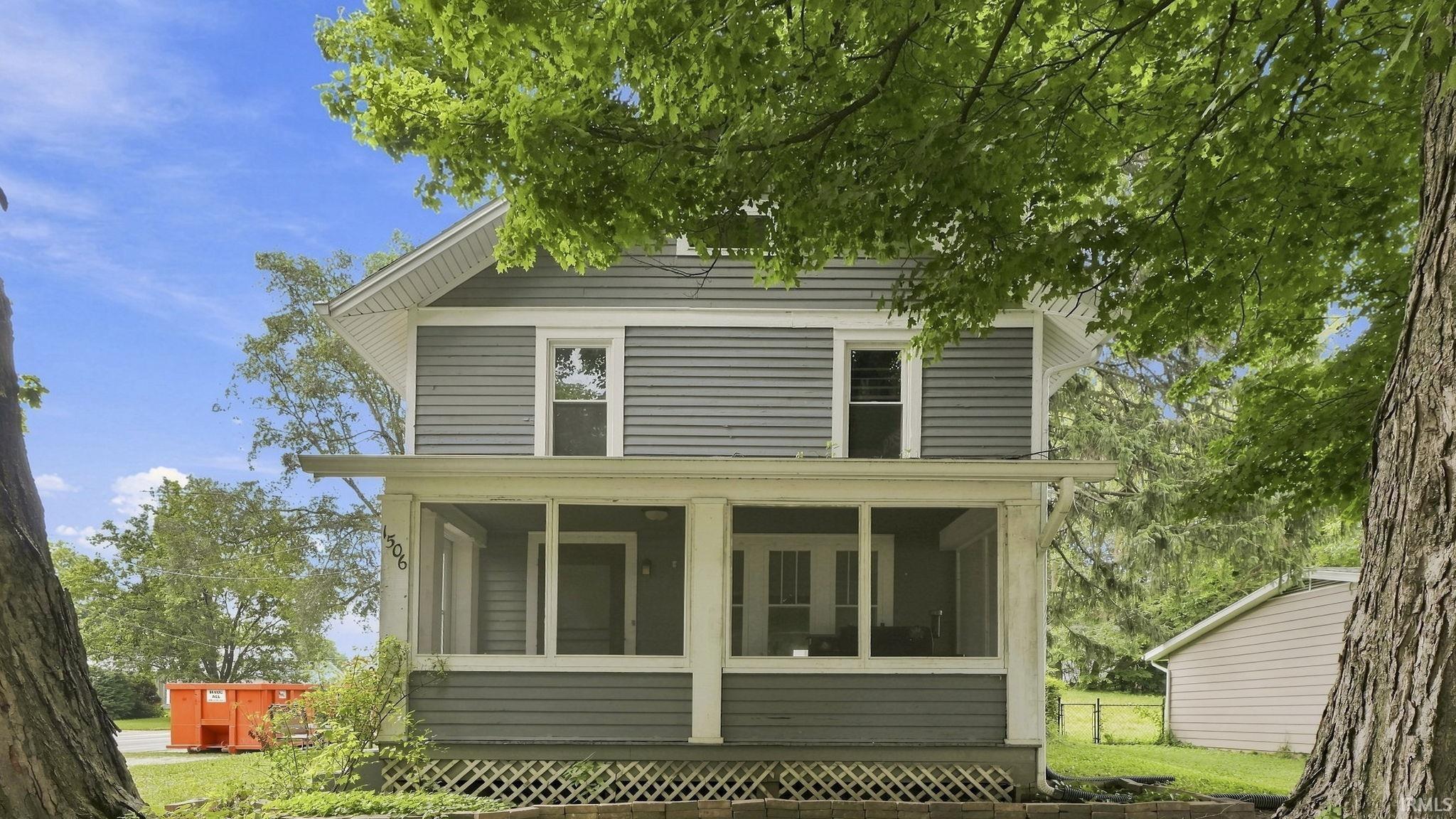 Two-story residence featuring gray horizontal siding and white trim