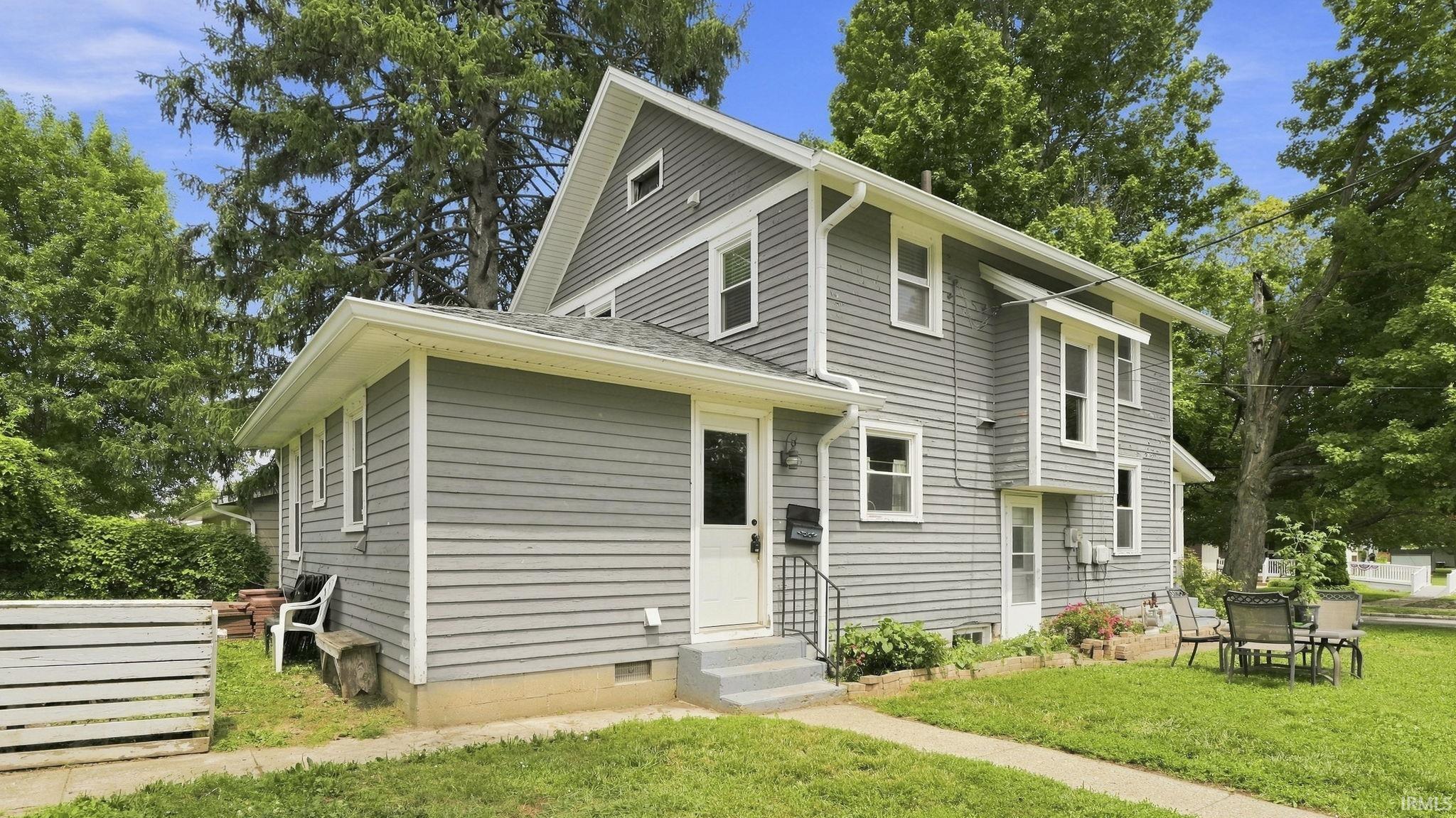 Two-story residence featuring gray horizontal siding and white trim