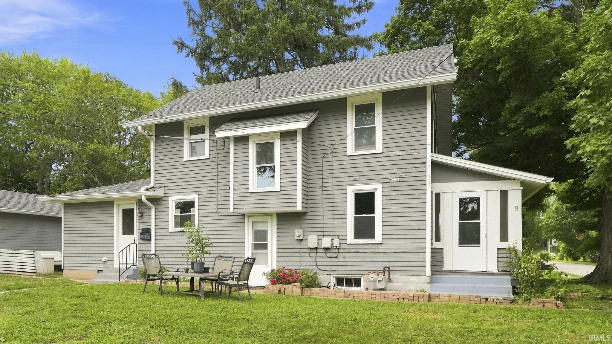 Gray siding exterior with white window frames and a gray shingle roof