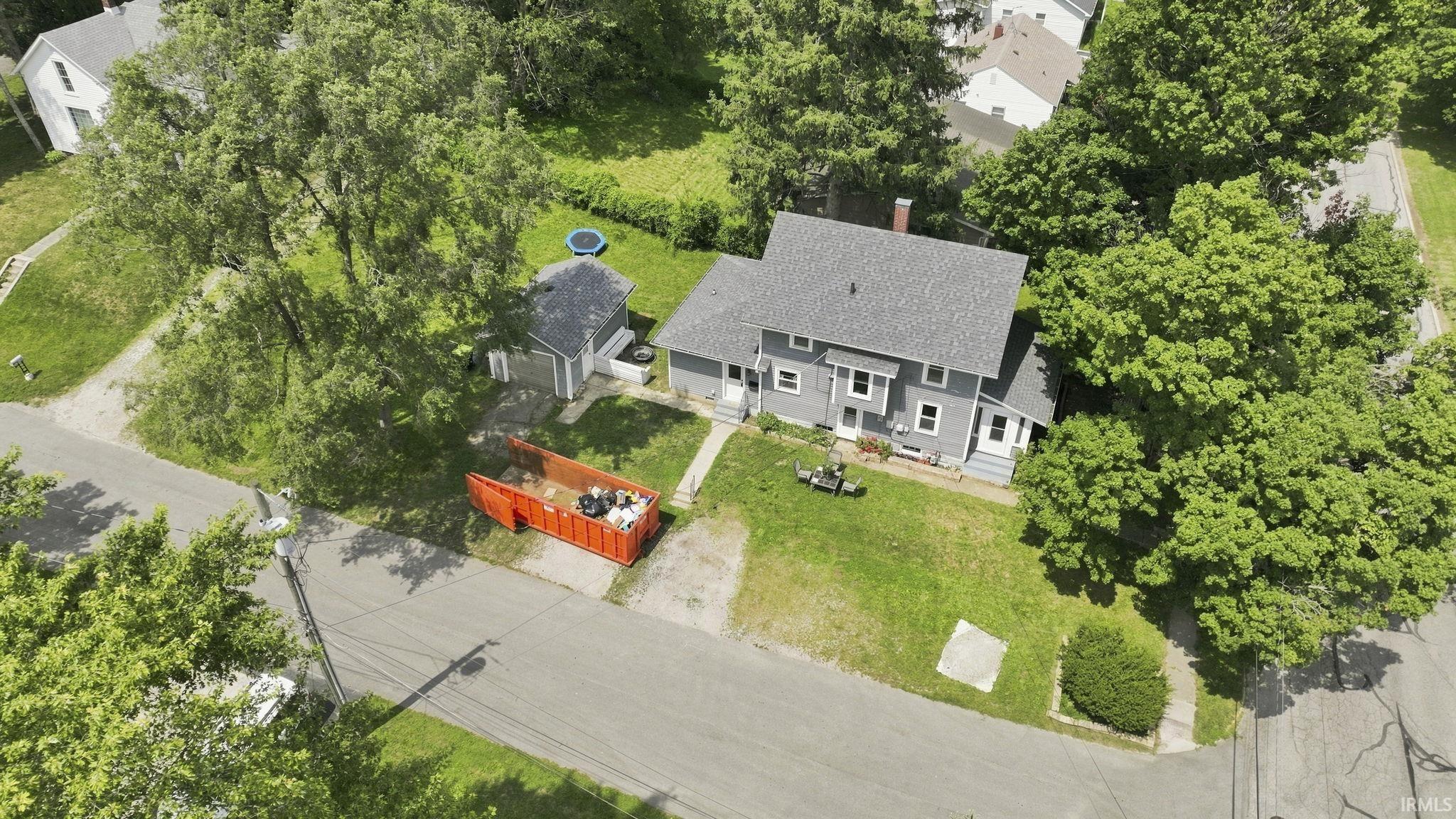 Two-story residence with a gray exterior, complemented by a dark gray shingle roof