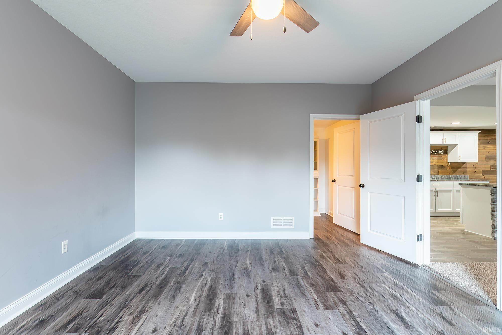 Neutral gray wall finishes complementing wood-finish flooring