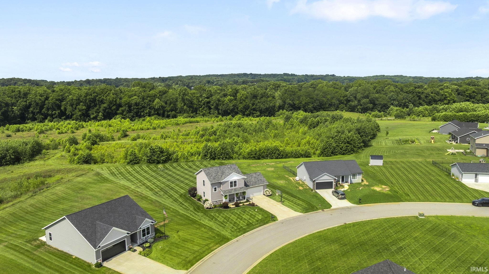 Residential properties featuring manicured lawns and a curved street