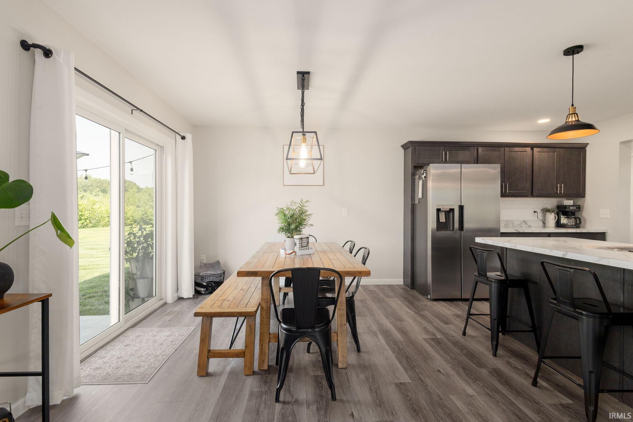 Open-concept kitchen and dining area featuring wood-finish flooring