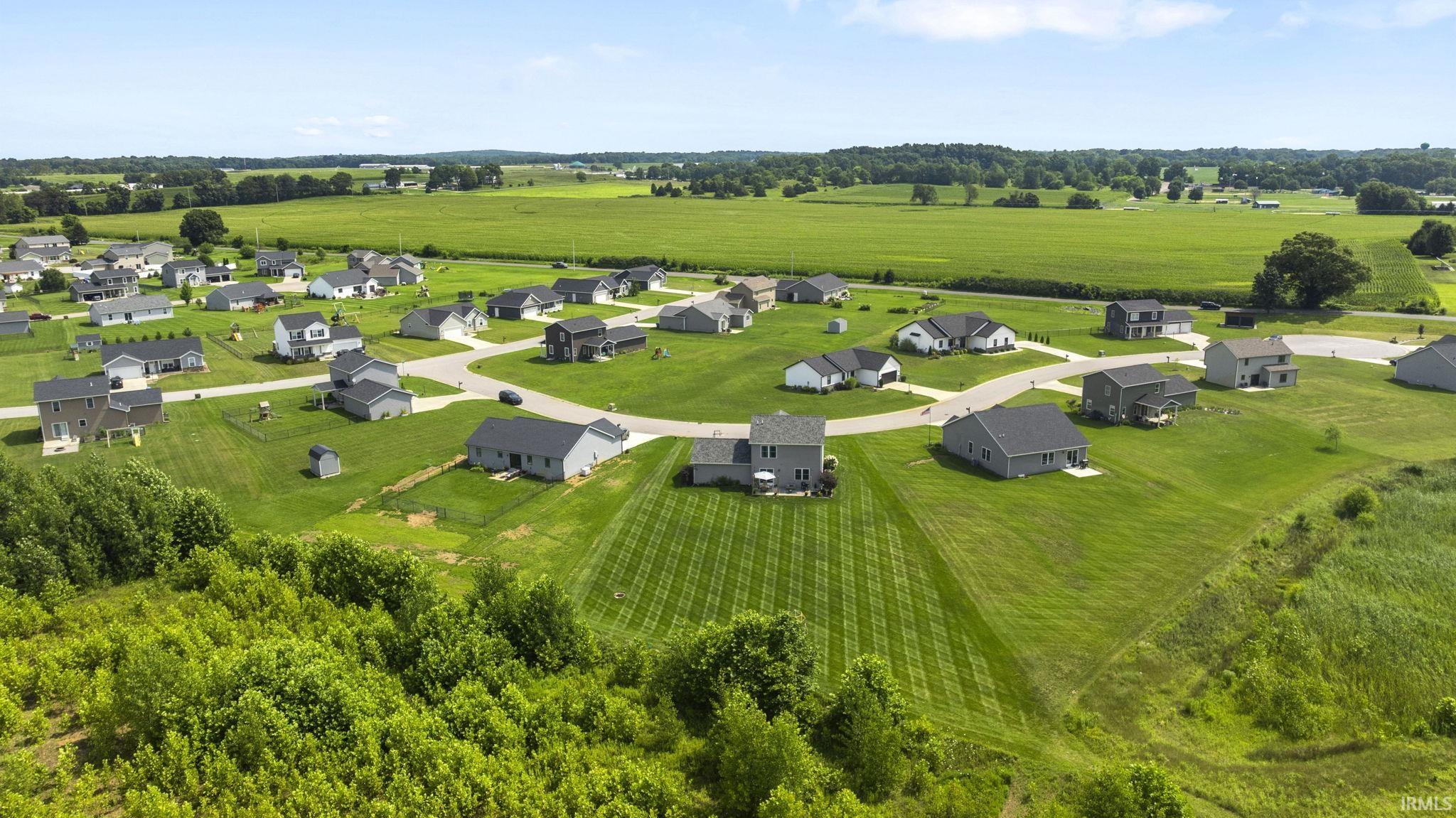 Residential development with varied architectural styles, surrounded by extensive green spaces
