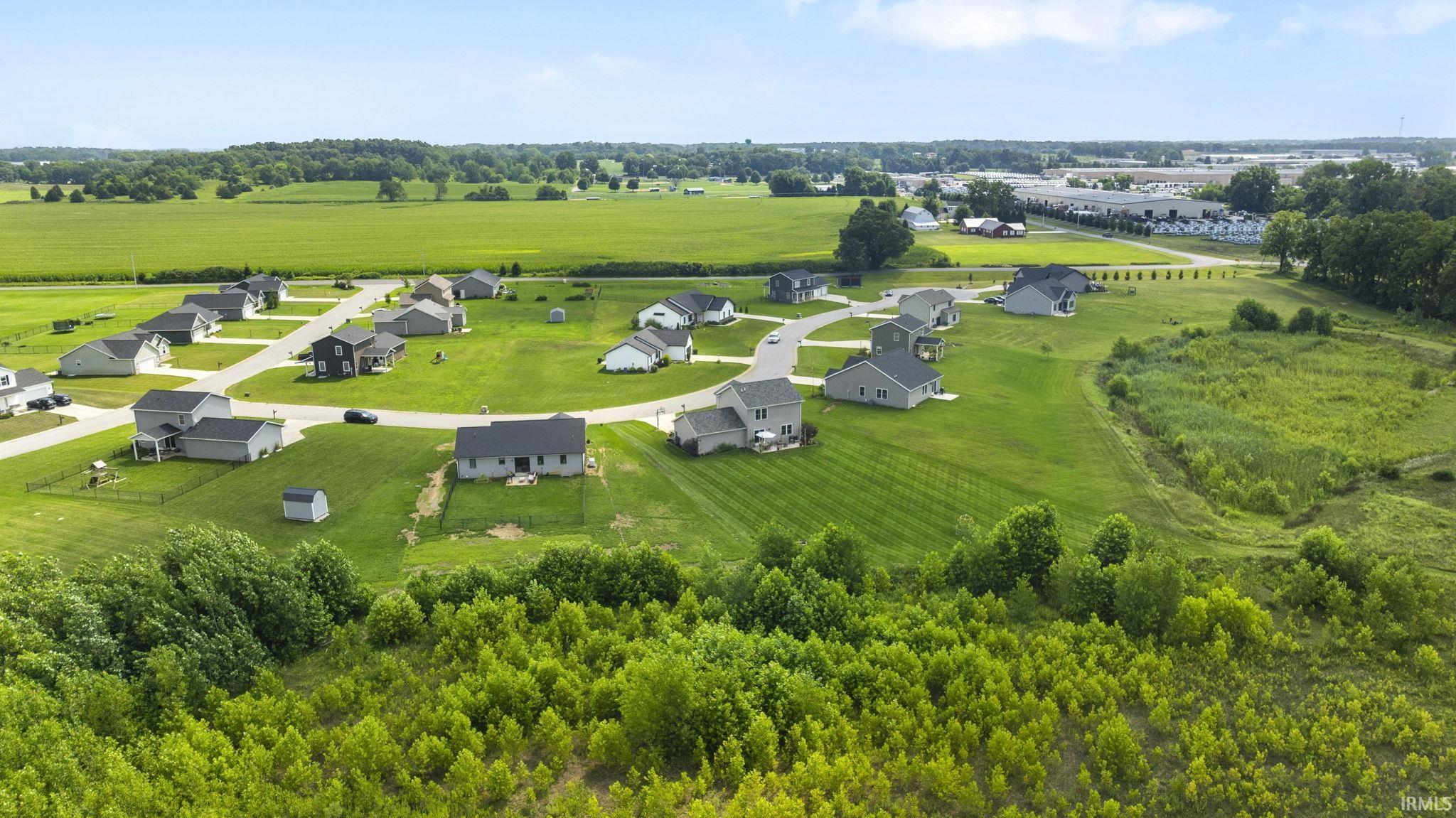 Residential development featuring single-family homes, paved roads, and manicured lawns