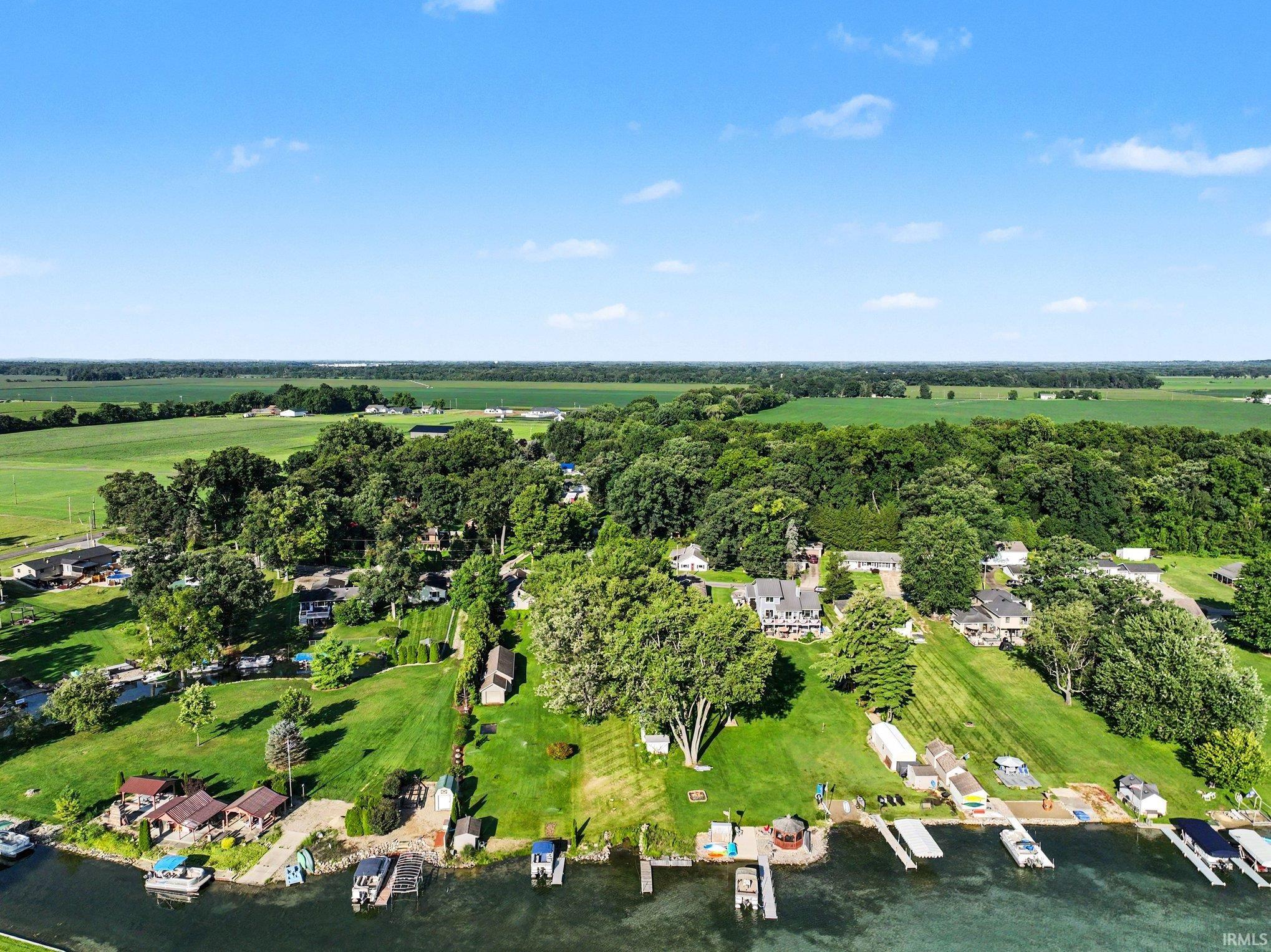 Expansive aerial perspective showcasing numerous waterfront properties with private docks