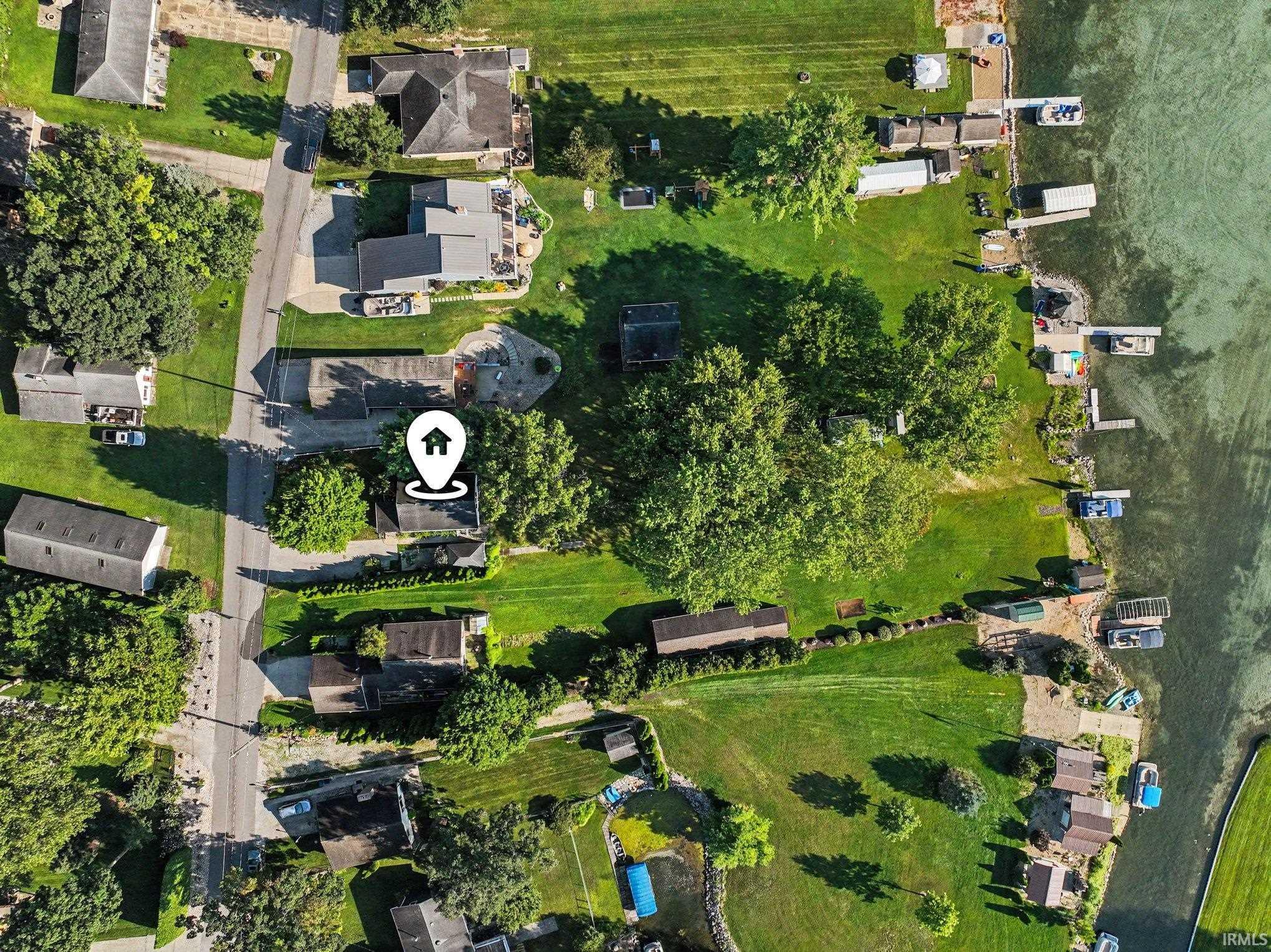 Aerial perspective showcasing a waterfront property with direct access to the water