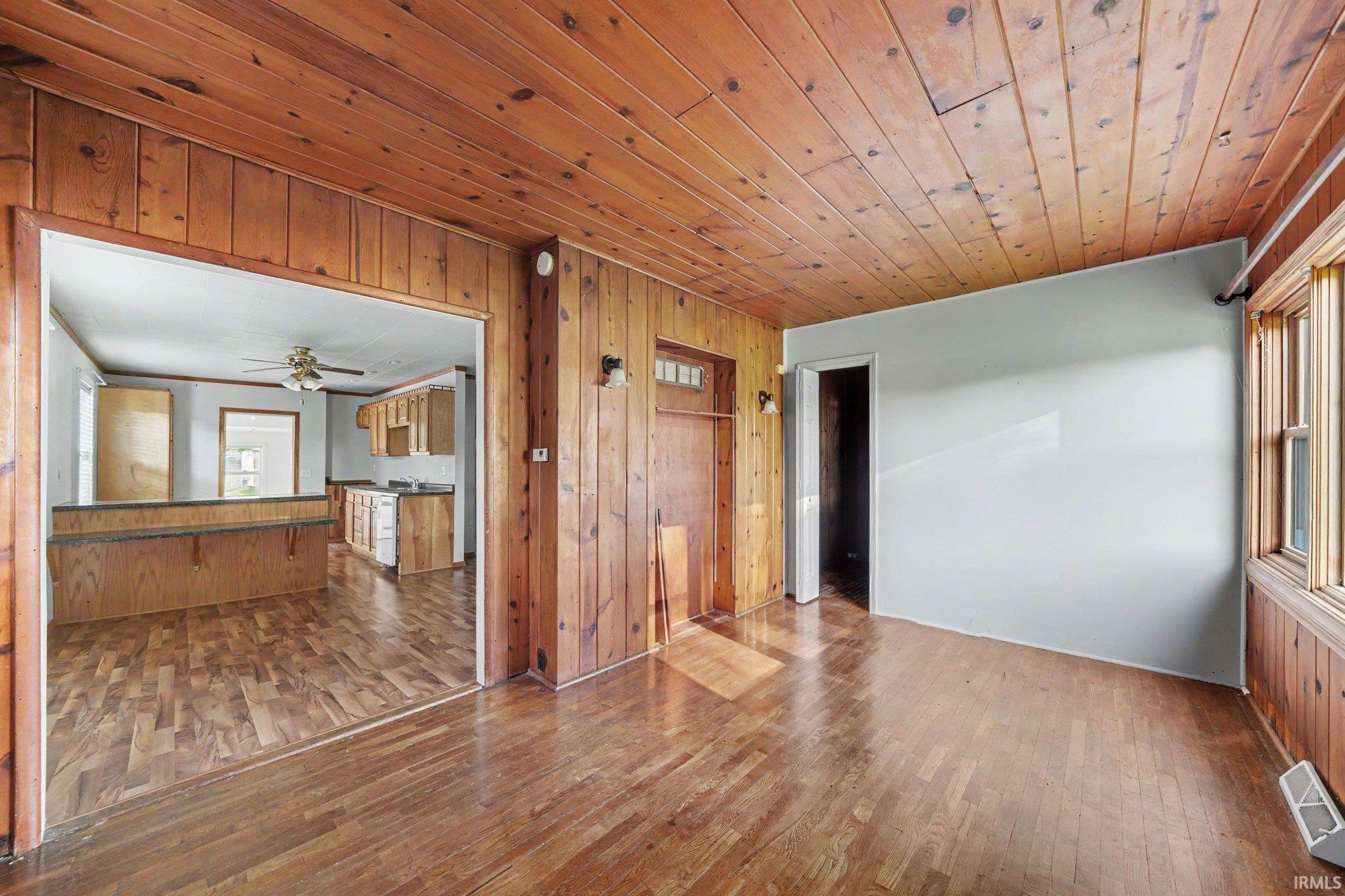 Interior room featuring wood-panel walls and ceiling with coordinating wood-finish flooring