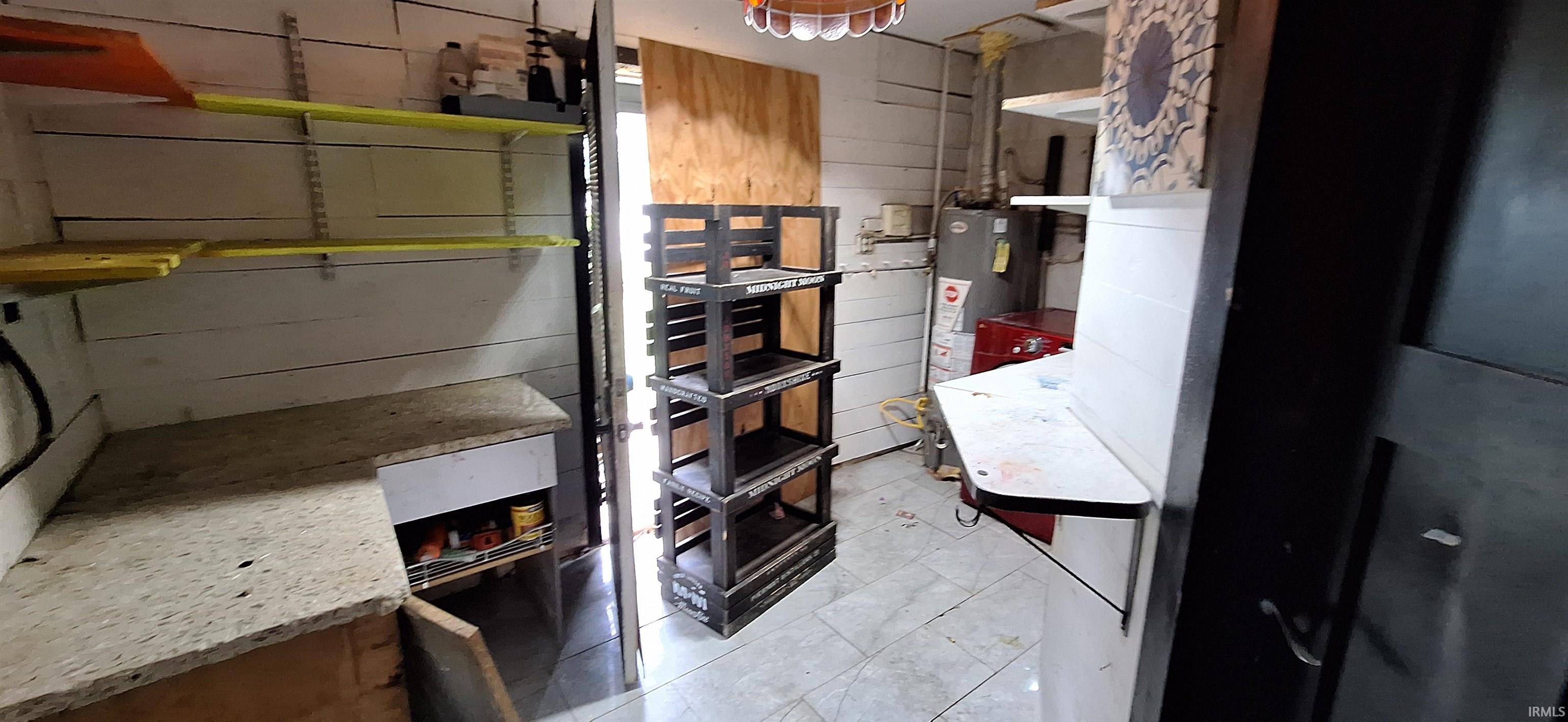 Utility room featuring tile flooring and horizontal paneling
