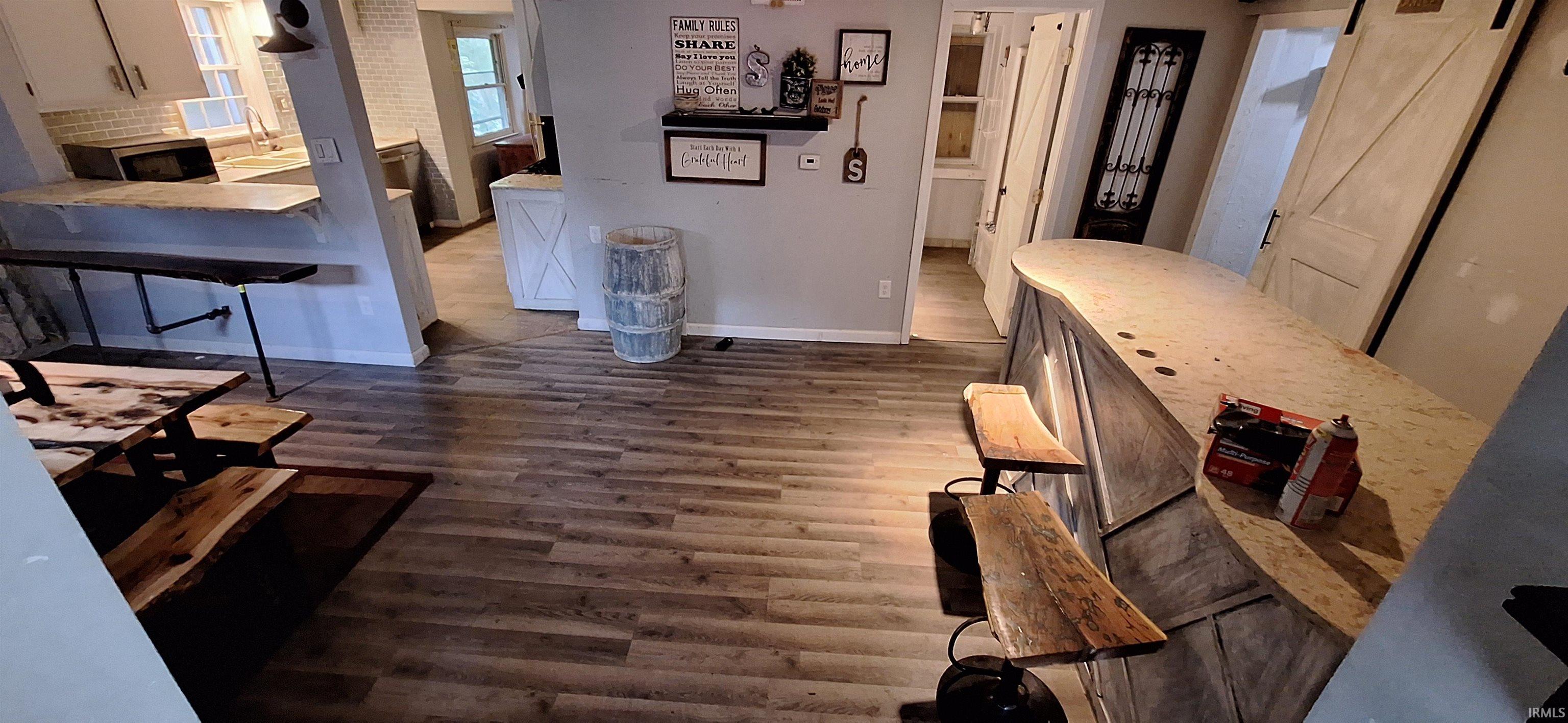 Wood-finish flooring extending throughout the open-concept space