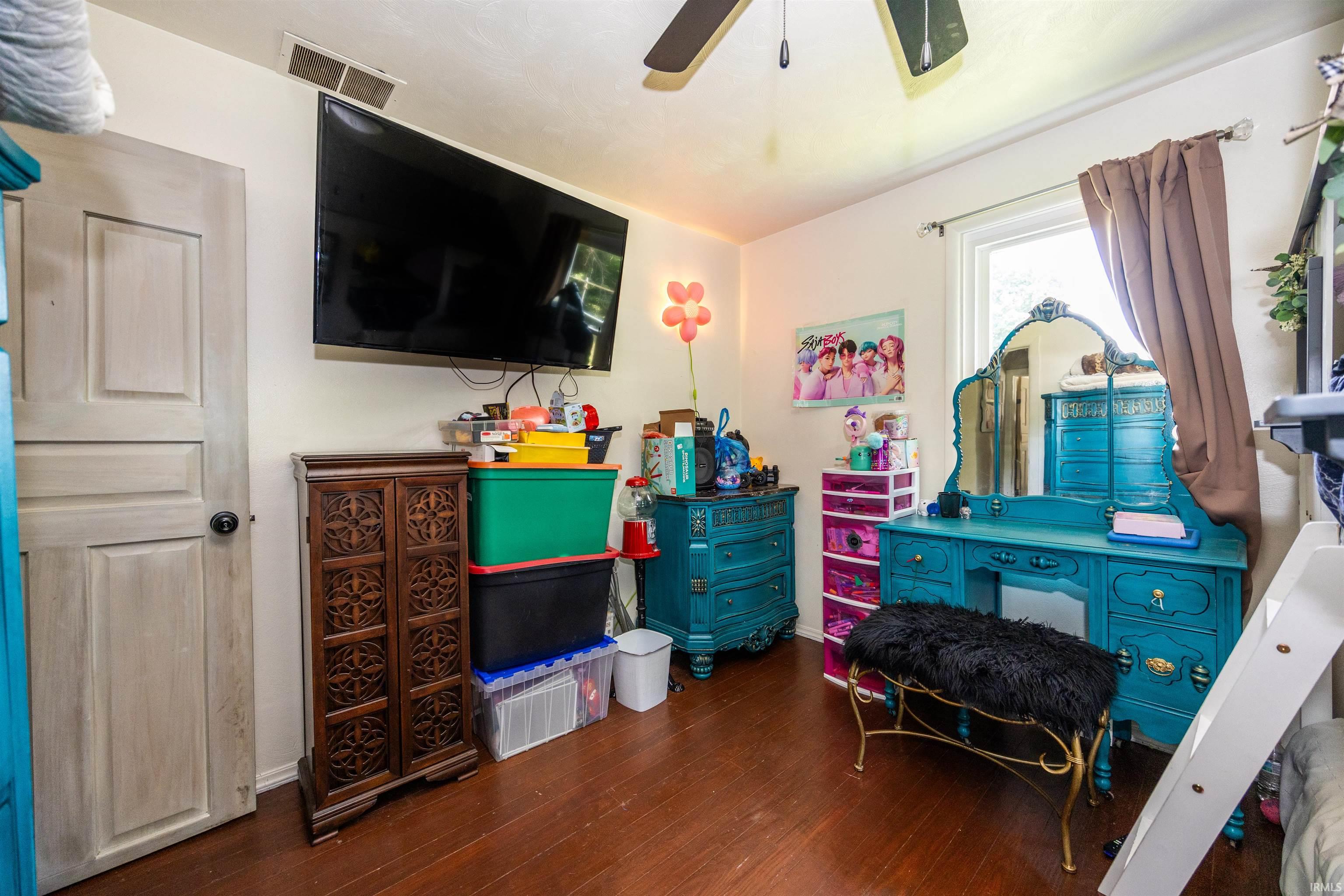 Interior room featuring wood-finish flooring and a ceiling fan