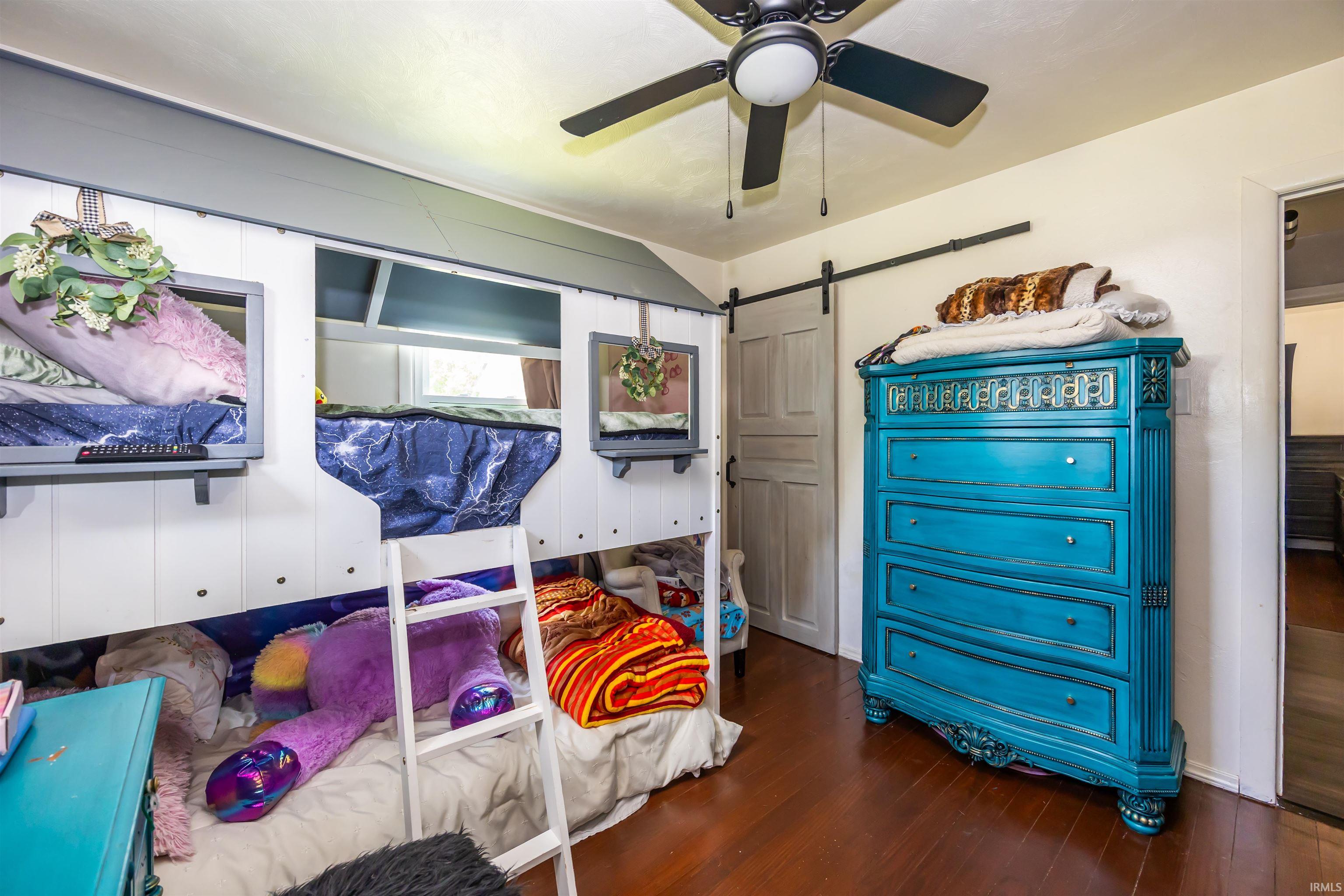 Built-in bunk beds with individual sleeping nooks and a ladder