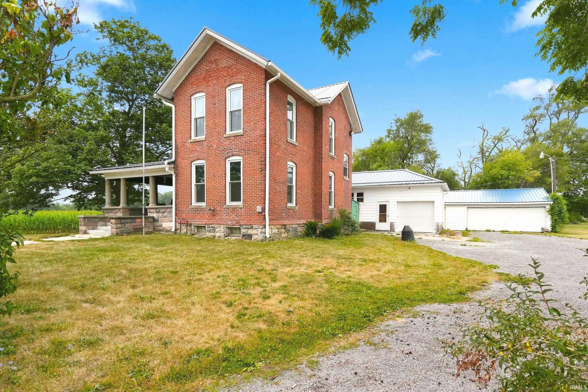 Brick exterior with a stone foundation and white trim
