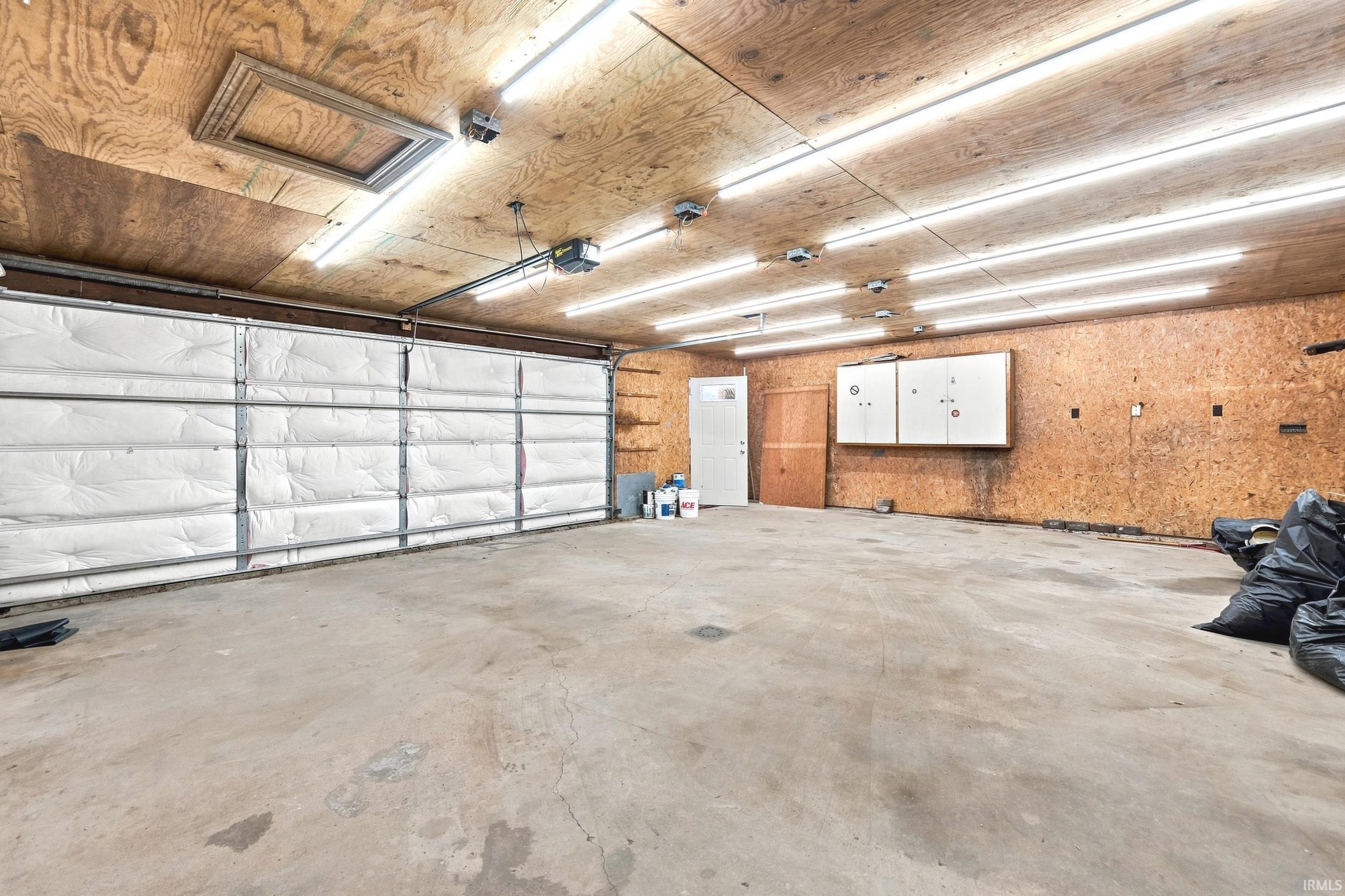 Spacious garage with exposed wood-finish walls and ceiling