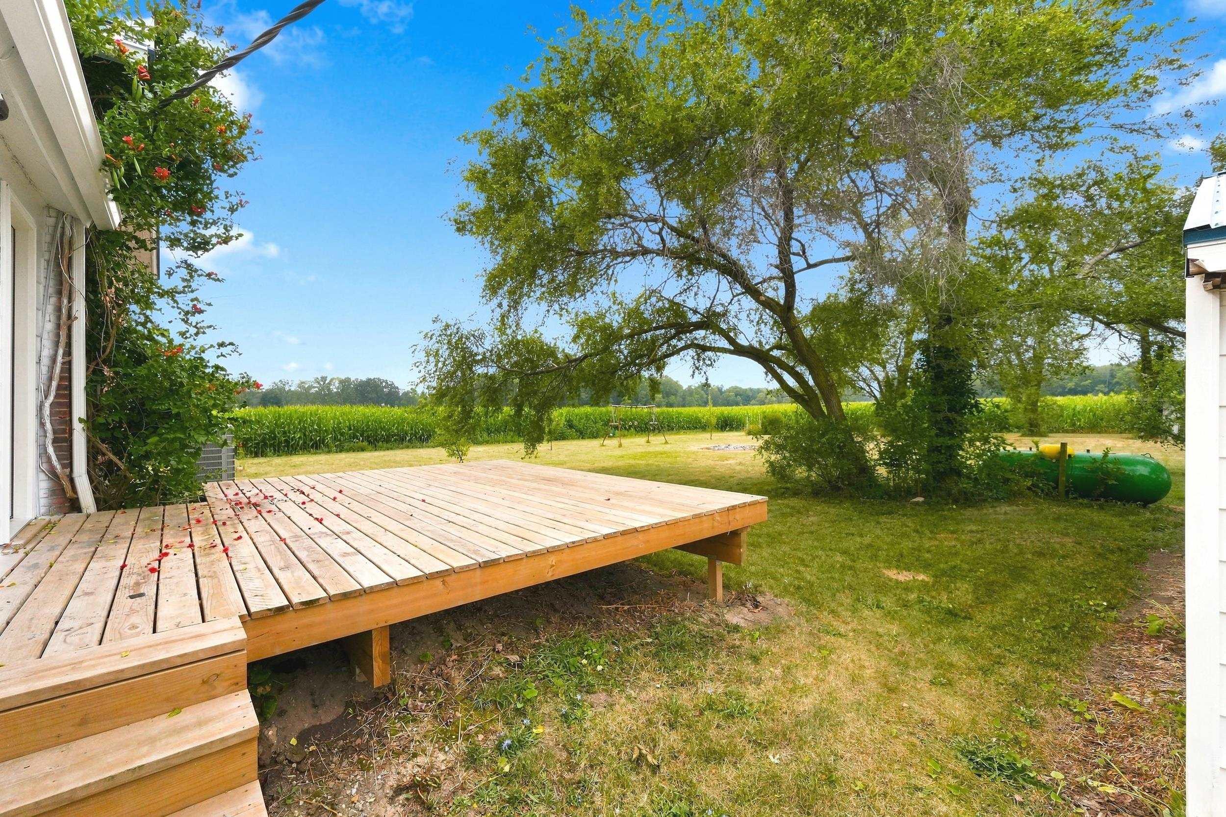 Expansive outdoor deck with natural wood planks and integrated steps