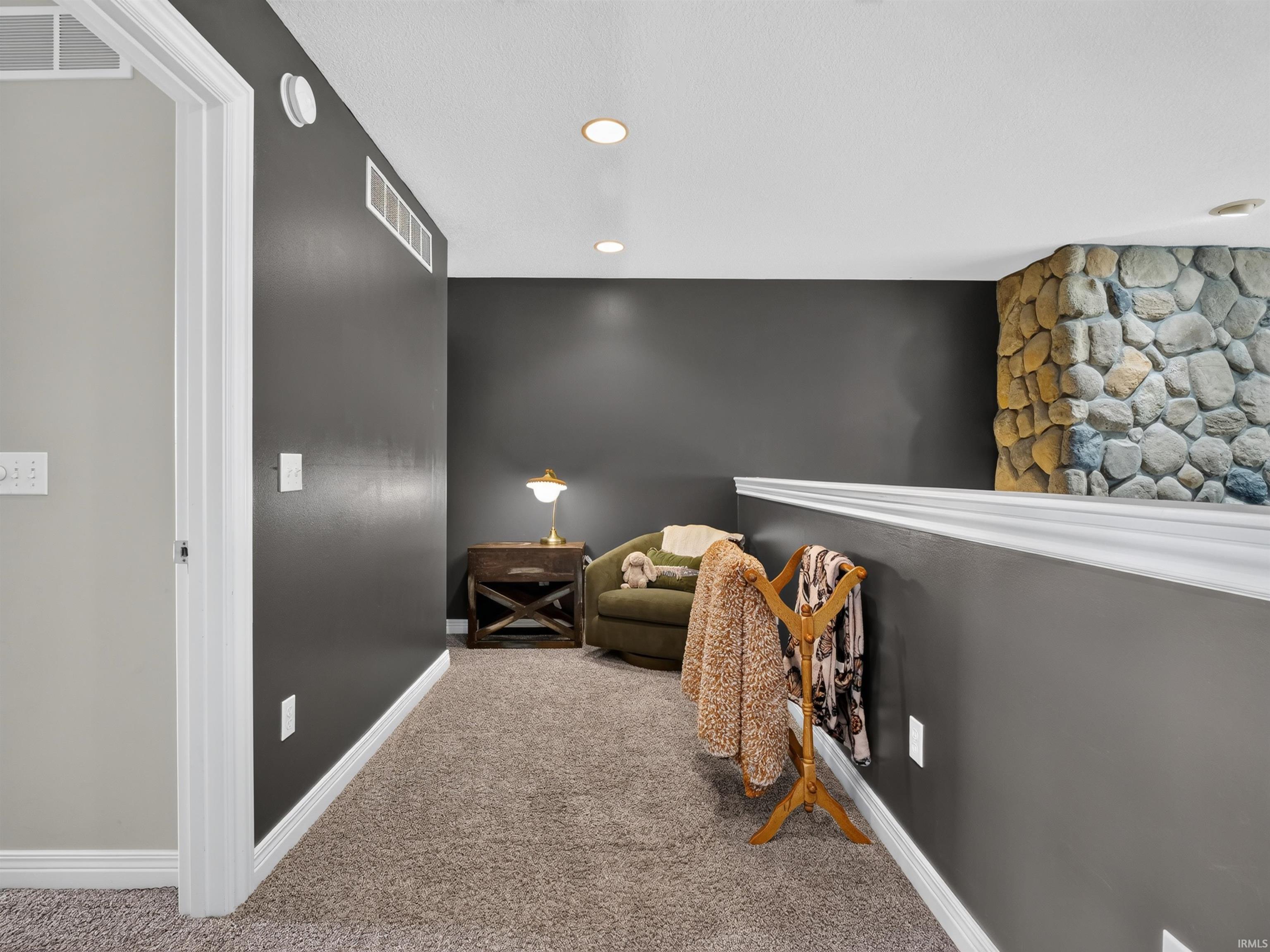 Recessed ceiling lighting, ceiling-mounted light fixture, dark wall paint, white trim, and carpeted flooring