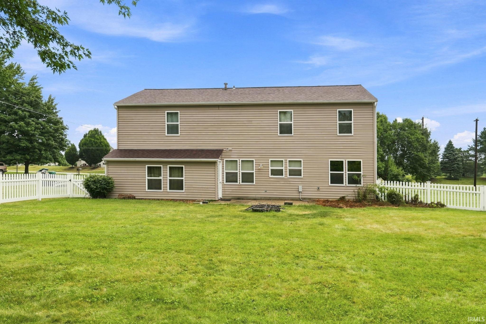 Two-story residential structure with horizontal siding and a gabled roof