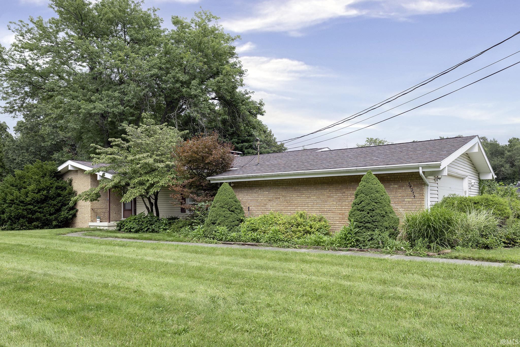 Brick exterior with a gabled roof and attached garage