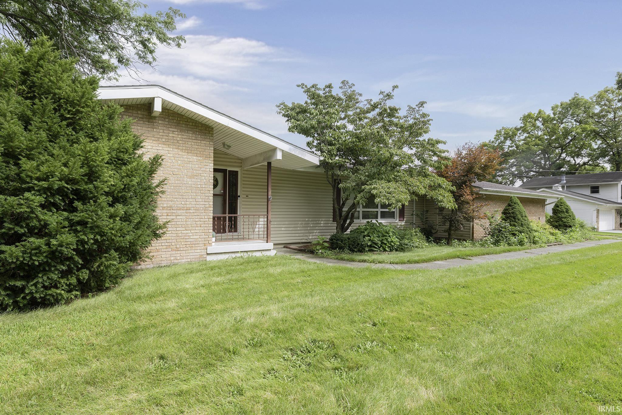 Brick and siding exterior with a covered entry