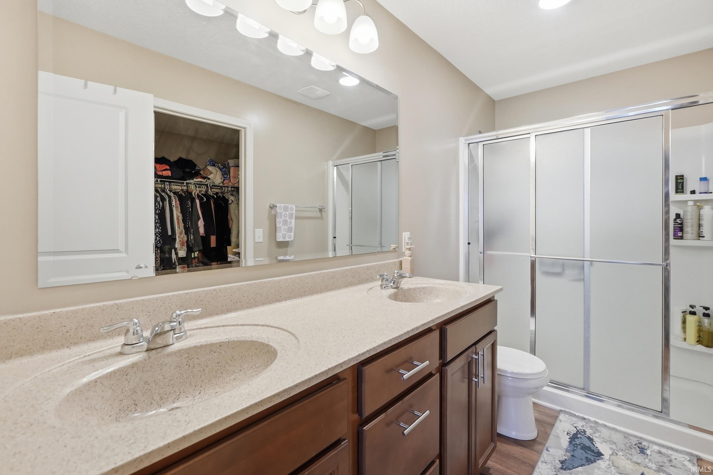 Double vanity with integrated sinks and a speckled countertop