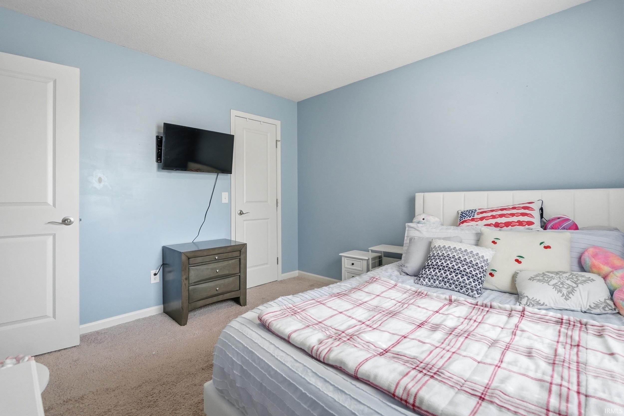 Carpeted room featuring light blue walls and white trim