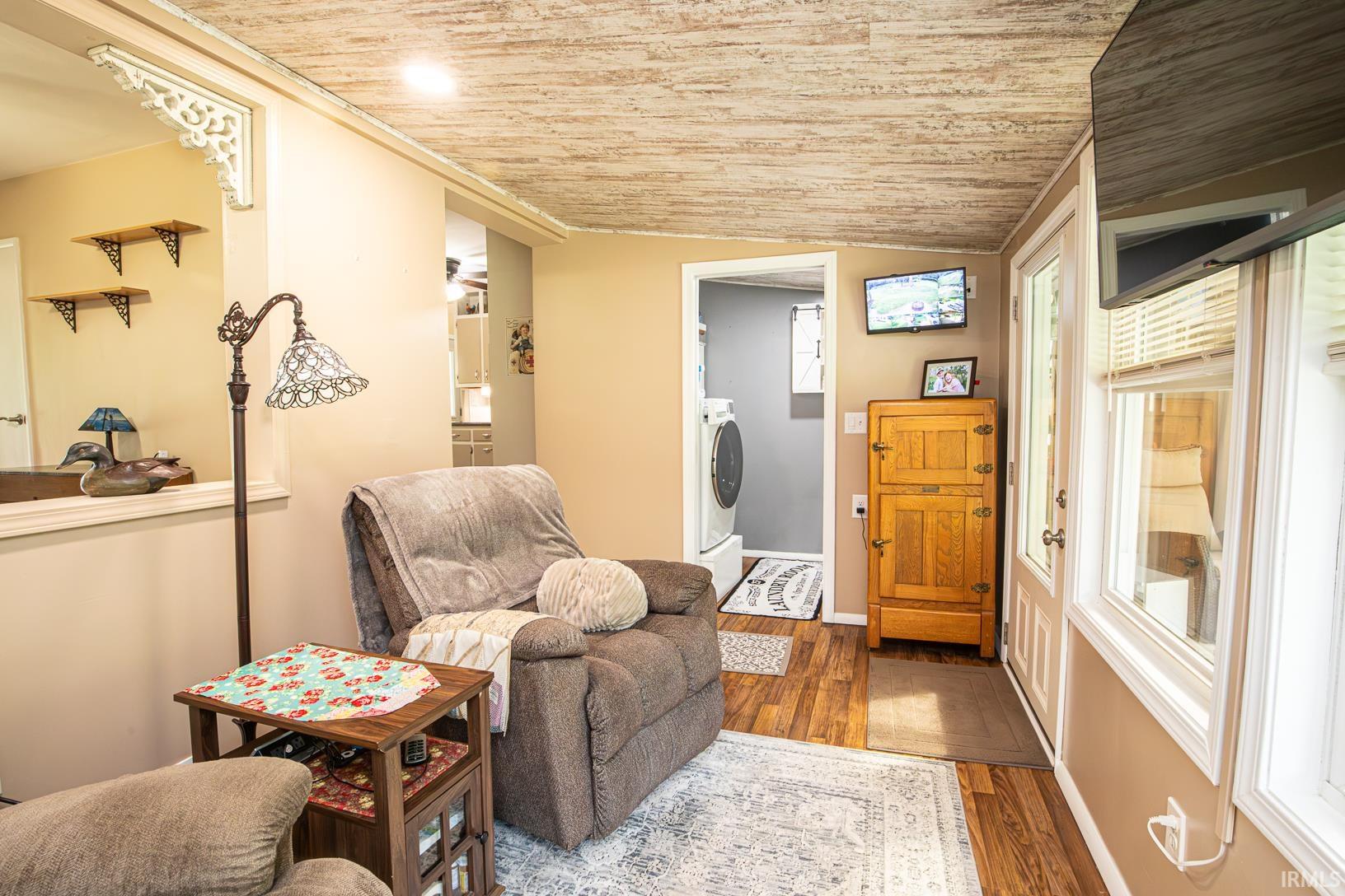Neutral-toned walls complement the wood-finish flooring throughout