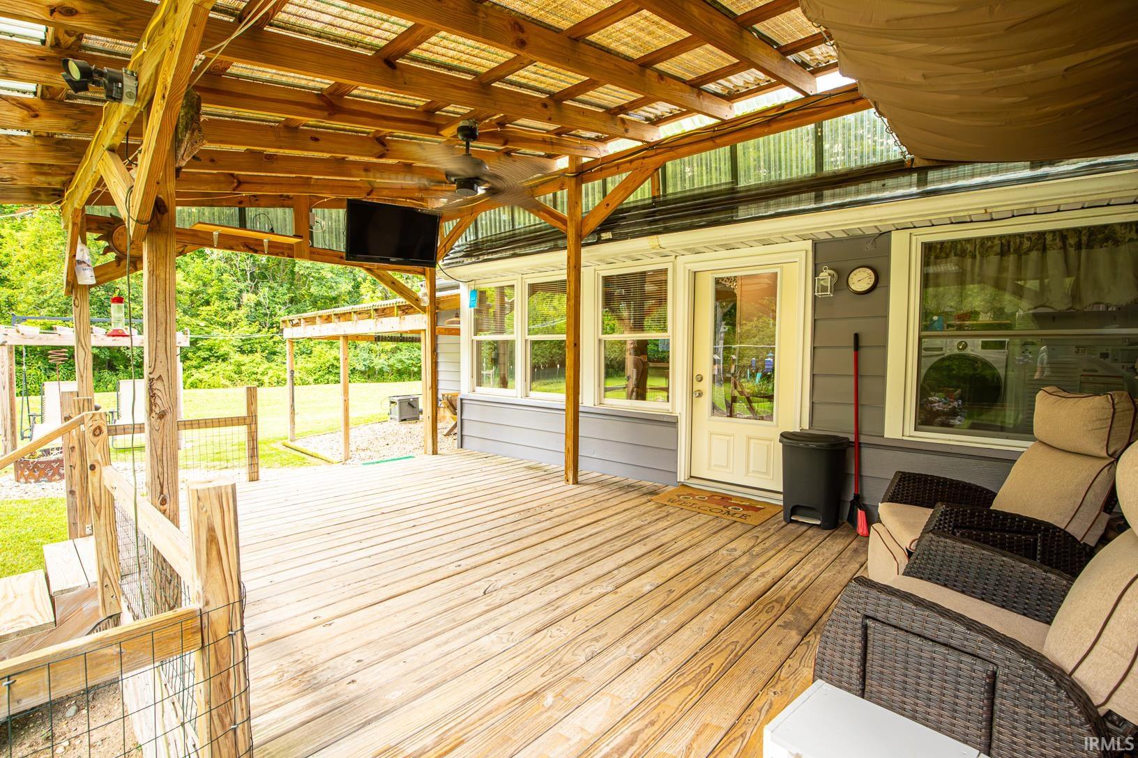 Expansive outdoor deck with a covered wooden pergola