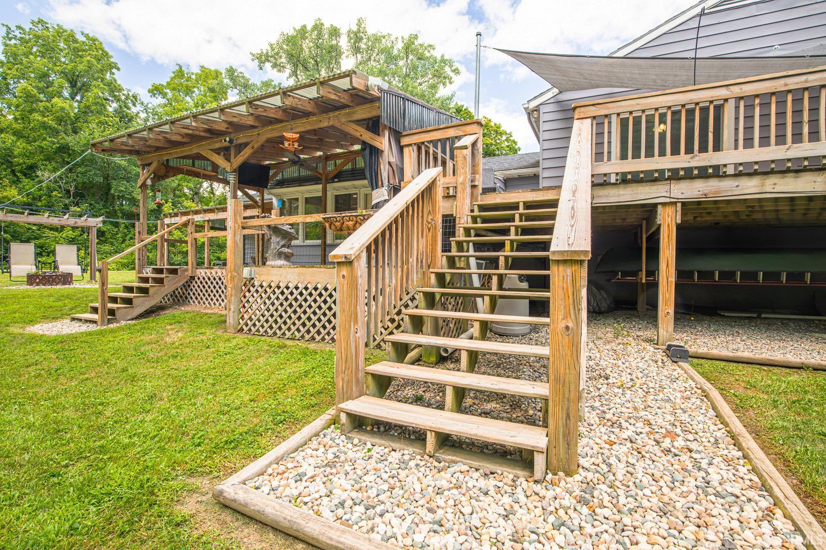 Multi-level wood deck featuring a covered outdoor area and multiple staircases