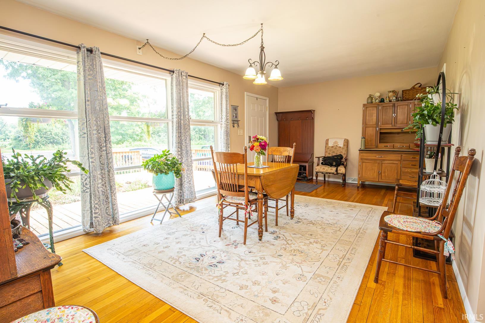 Spacious room featuring wood-finish flooring and a neutral color palette